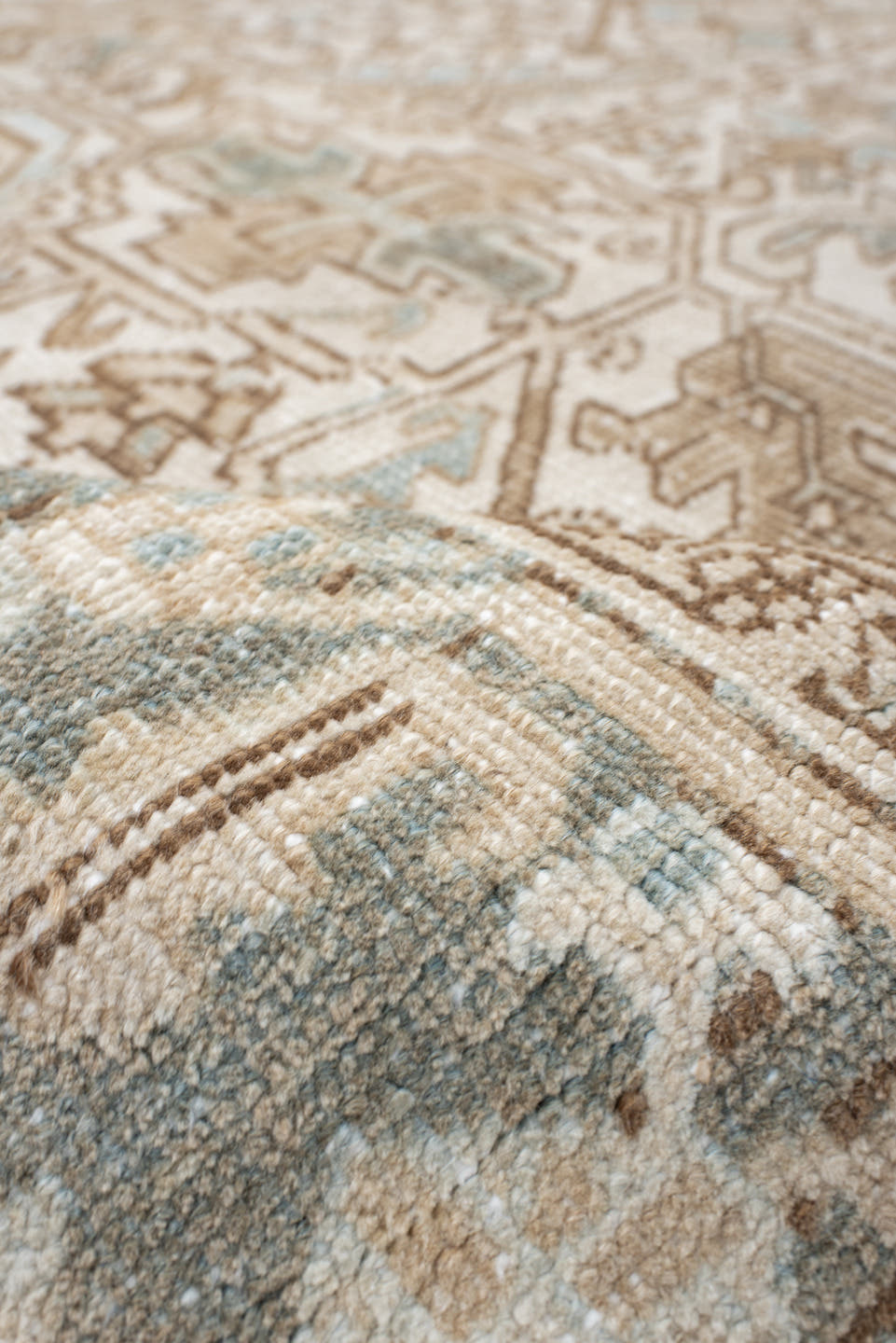 7' x 9' one-of-a-kind handmade antique Heriz rug. Color palette: ivory, camel, pale blue, taupe, beige, light gray