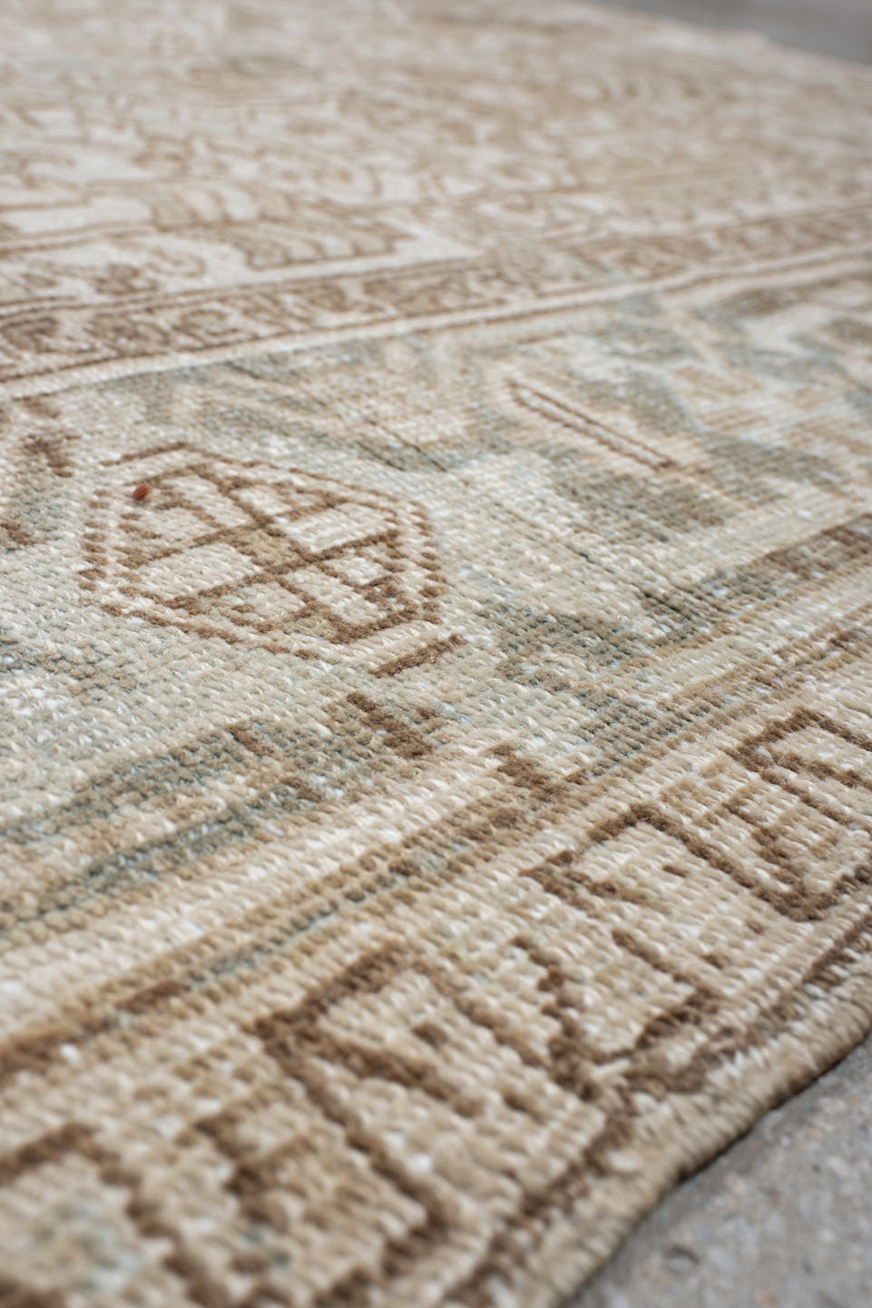 7' x 9' one-of-a-kind handmade antique Heriz rug. Color palette: ivory, camel, pale blue, taupe, beige, light gray