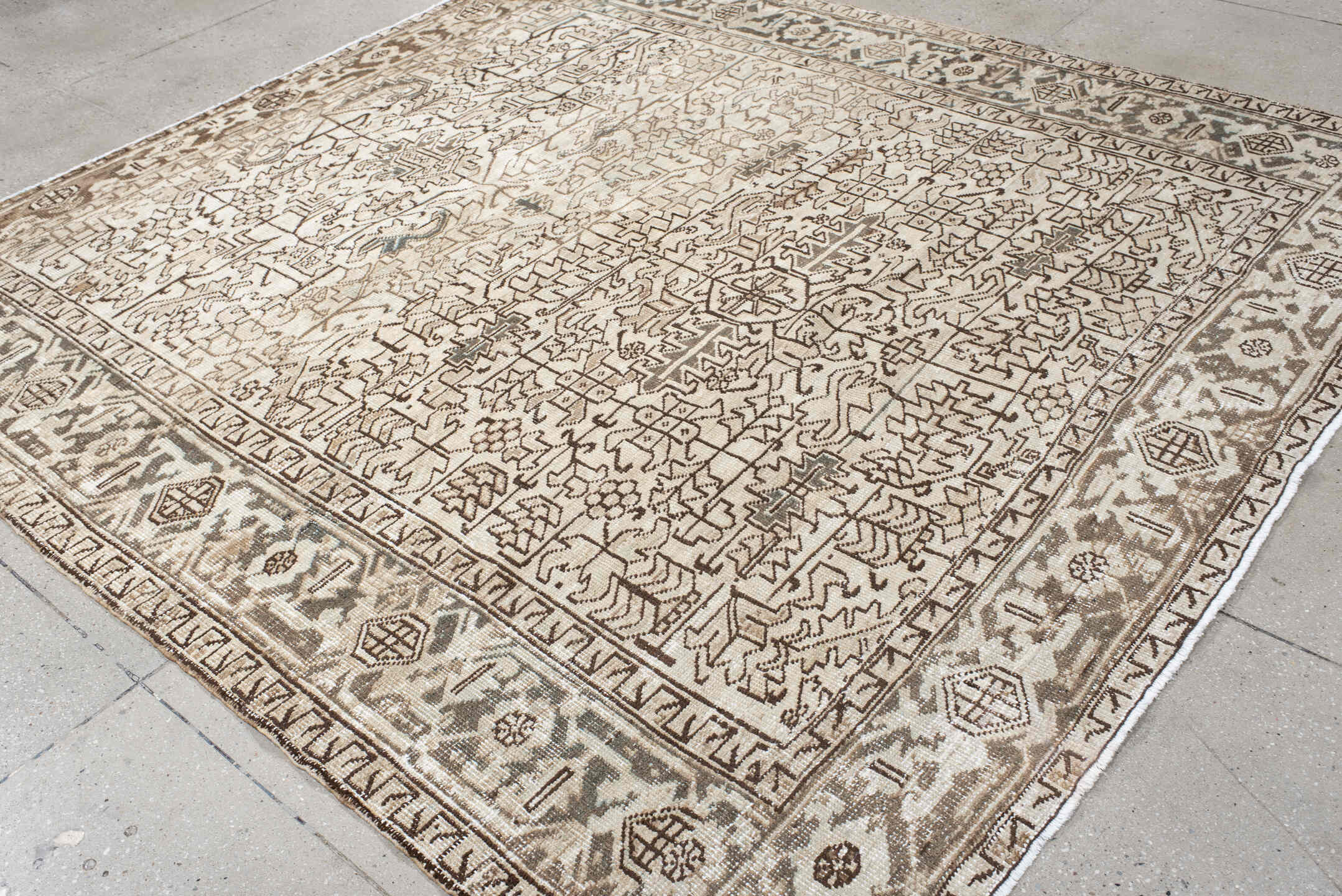 7' x 8' one-of-a-kind handmade antique Heriz rug. Color palette: ivory, taupe, brown, charcoal, beige, gray, black
