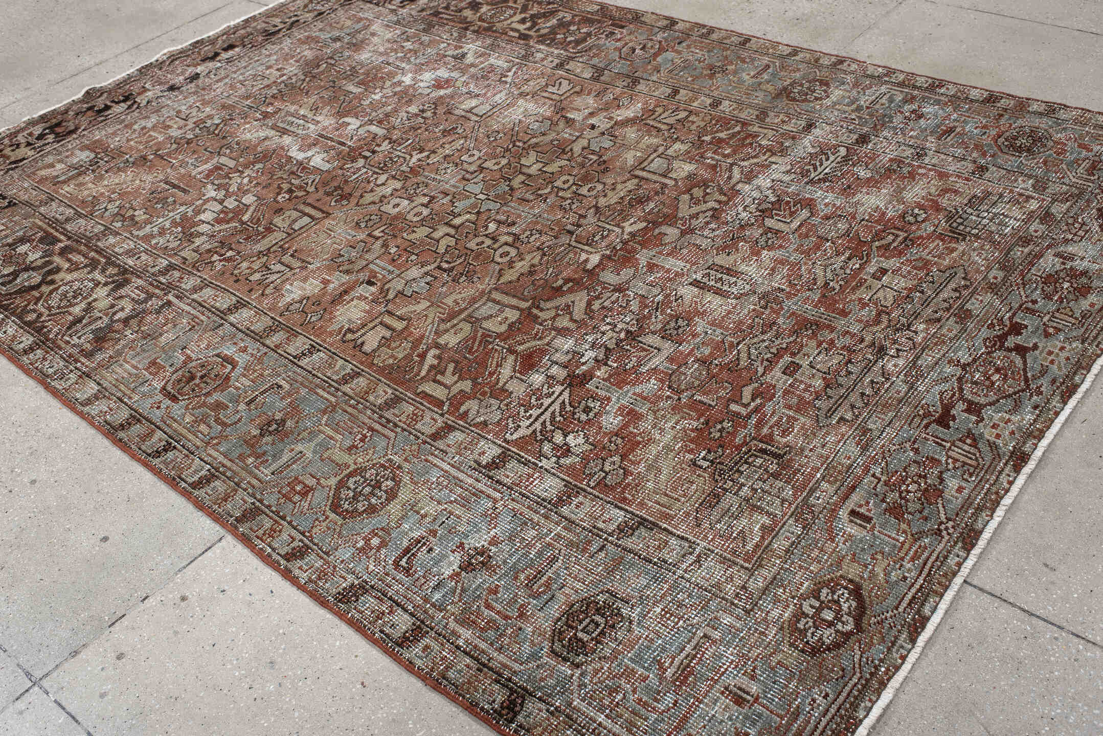 6' x 9' one-of-a-kind handmade antique Heriz medium size rug. Color palette: terra cotta, ivory, taupe, charcoal, slate