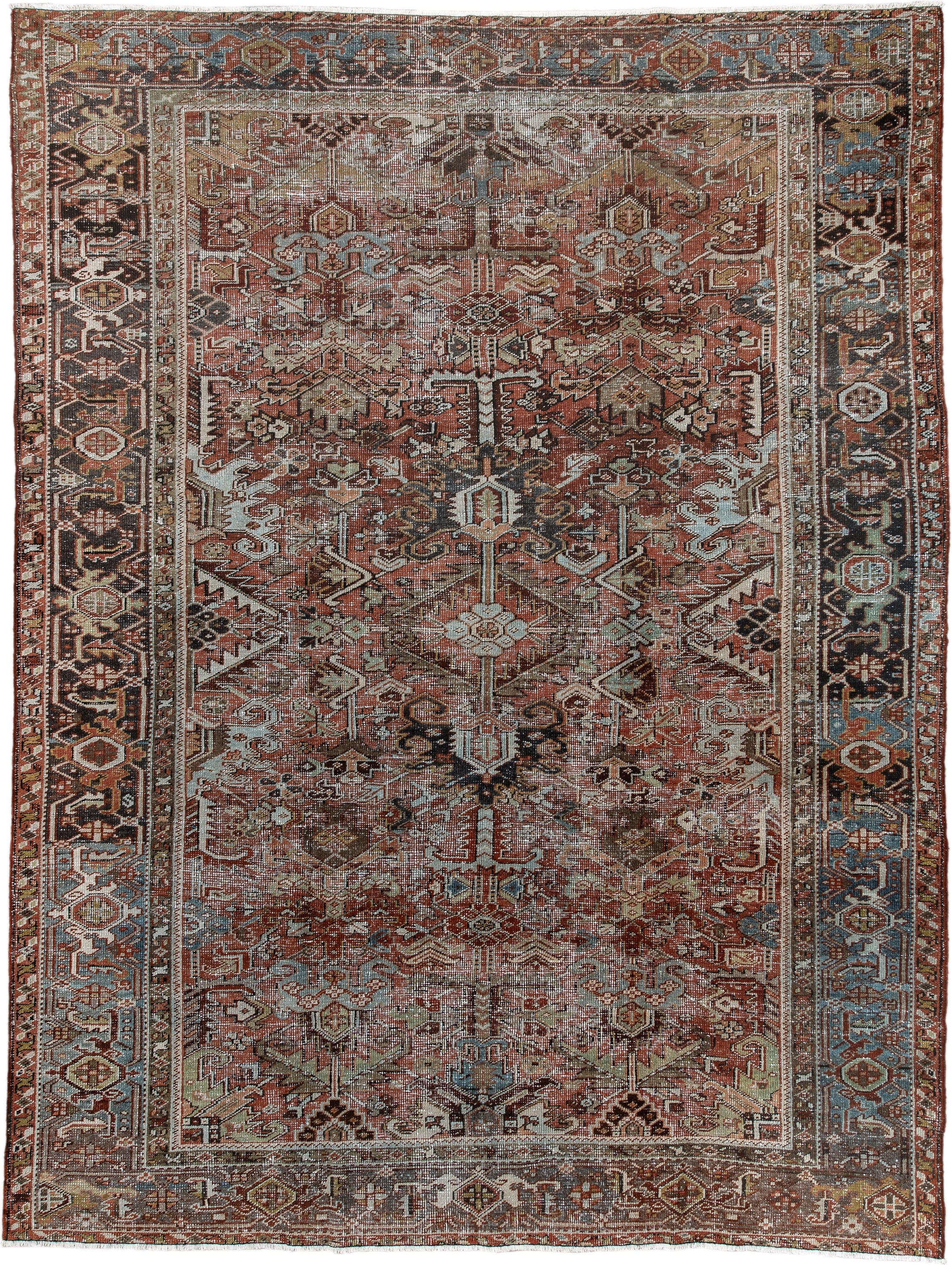 7' x 9' one-of-a-kind handmade antique Heriz rug. Color palette: rust, ivory, sky blue, charcoal, taupe, camel, brown
