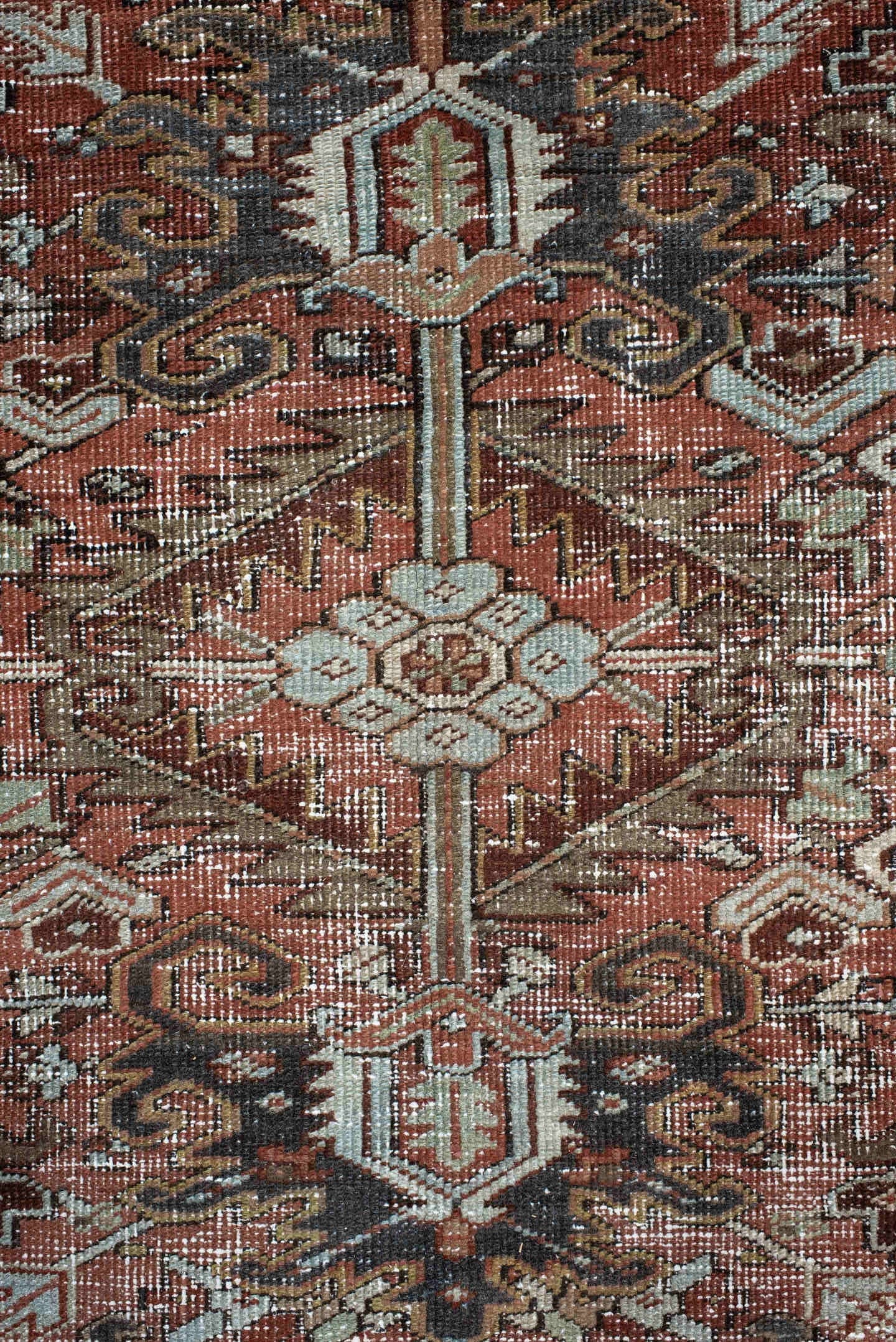 7' x 9' one-of-a-kind handmade antique Heriz rug. Color palette: rust, ivory, sky blue, charcoal, taupe, camel, brown