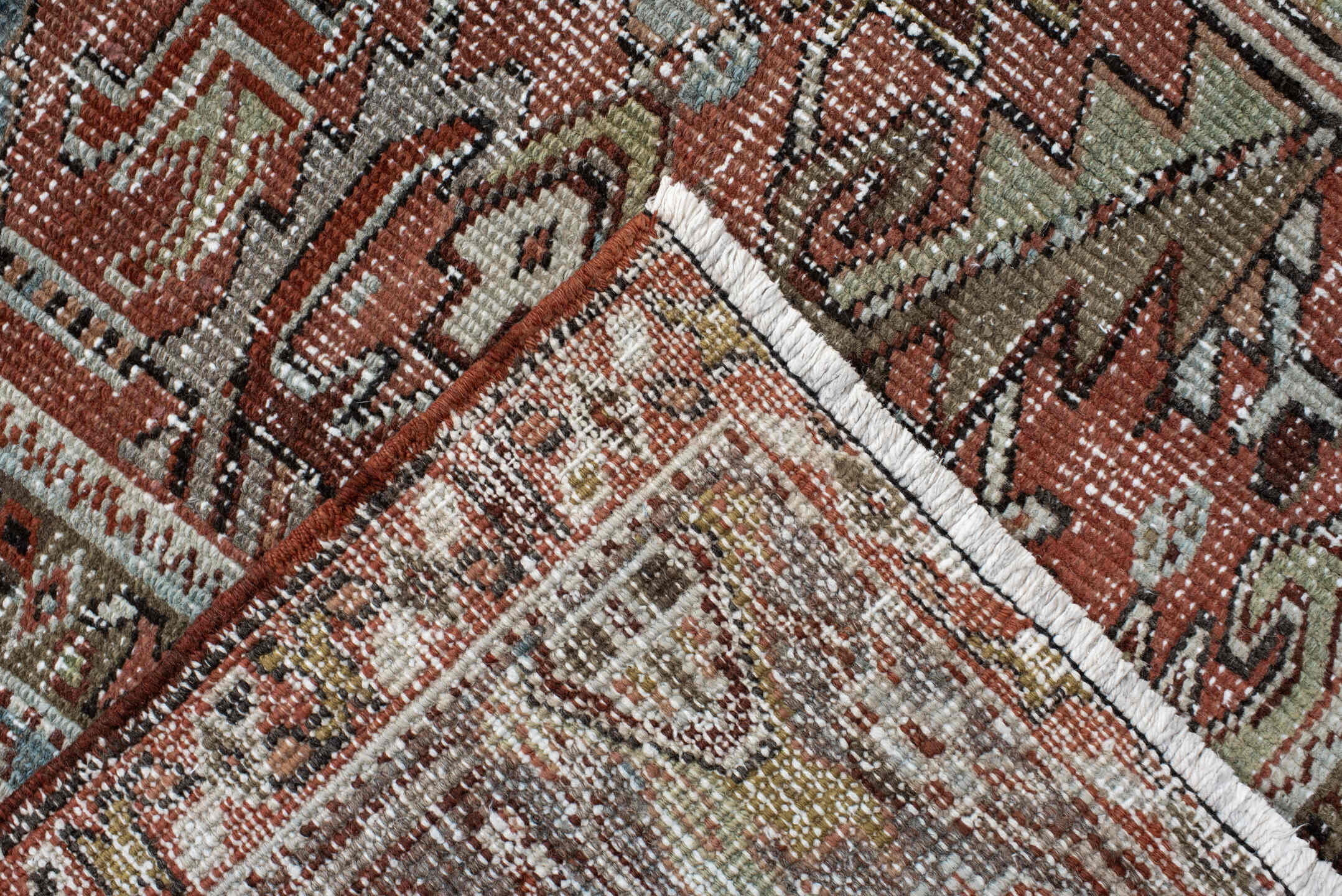 7' x 9' one-of-a-kind handmade antique Heriz rug. Color palette: rust, ivory, sky blue, charcoal, taupe, camel, brown