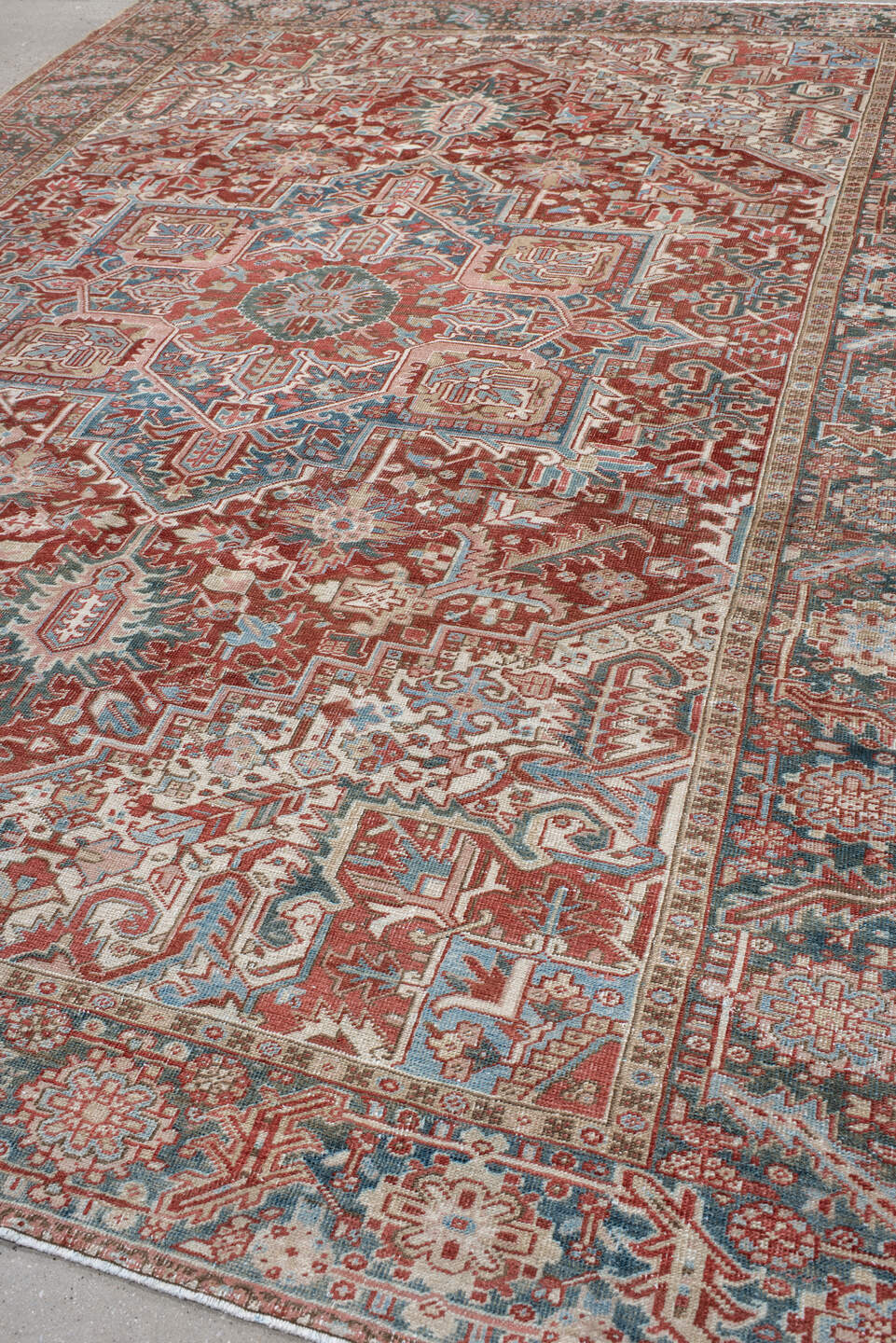 8' x 12' one-of-a-kind handmade antique Heriz large size rug. Color palette: rust, ivory, sky blue, slate, brick, cream