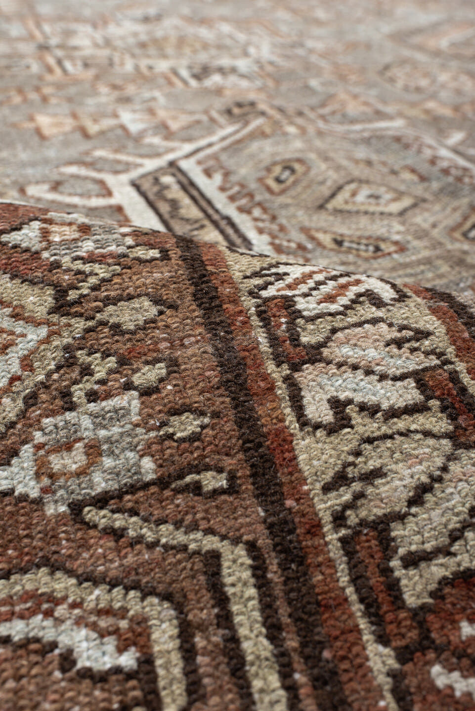7' x 10' one-of-a-kind handmade vintage Karaje large size rug. Color palette: taupe, brown, ivory, camel, slate, rust, beige