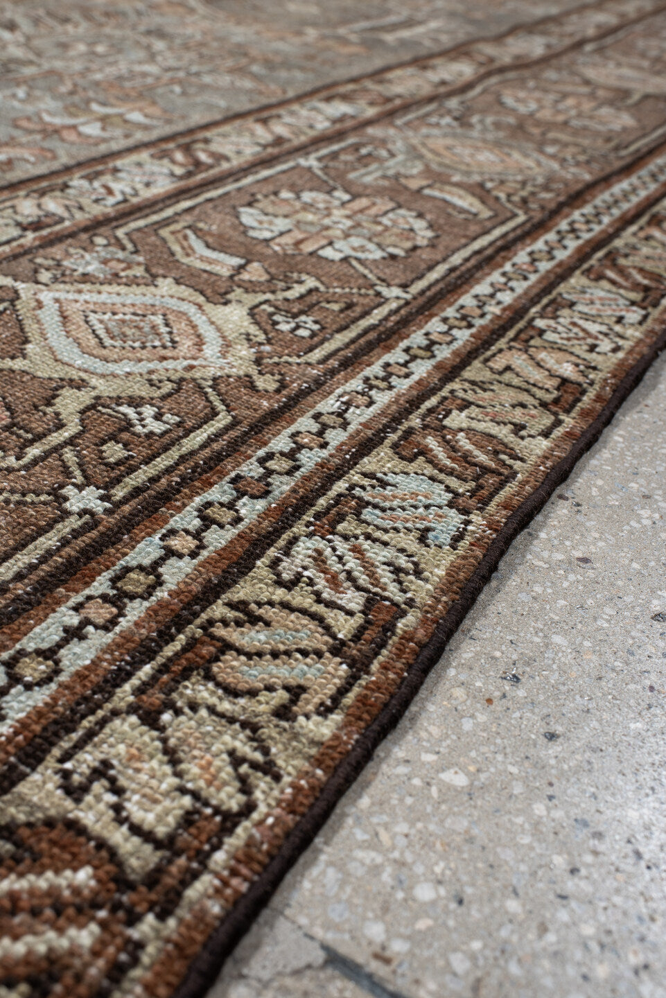 7' x 10' one-of-a-kind handmade vintage Karaje large size rug. Color palette: taupe, brown, ivory, camel, slate, rust, beige