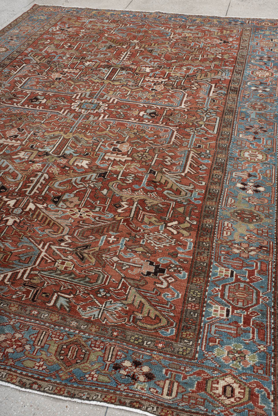 7' x 11' one-of-a-kind handmade antique Heriz large size rug. Color palette: rust, sky blue, ivory, taupe, charcoal, camel