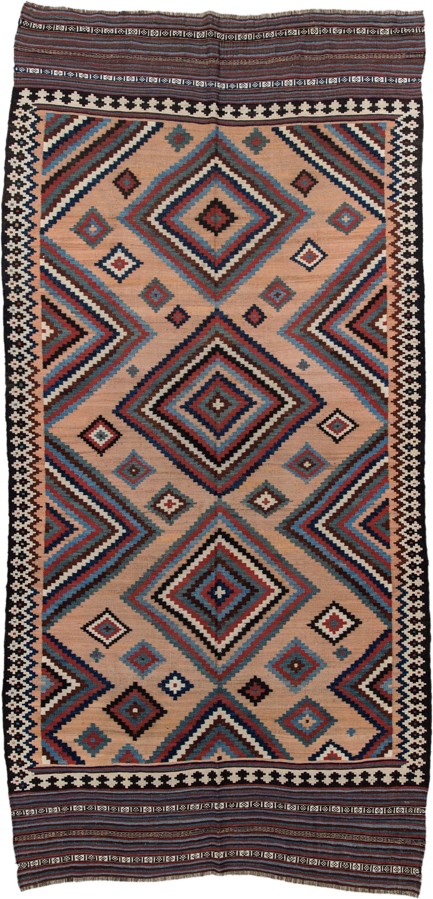 5' x 10' one-of-a-kind handmade antique Kilim runner rug. Color palette: camel, indigo, ivory, rust, turquoise, charcoal
