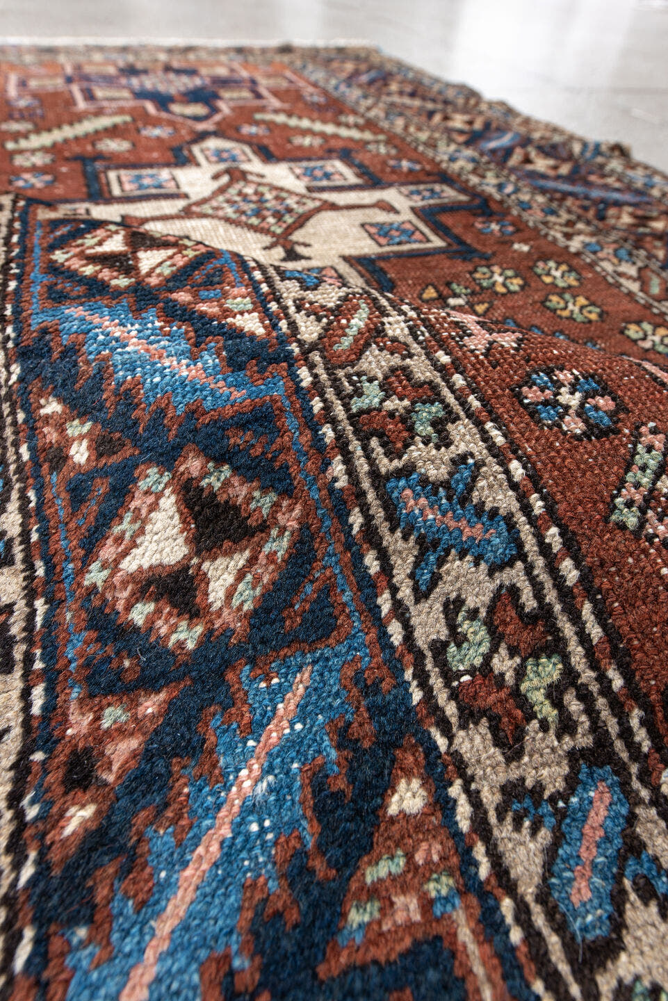 3' x 5' one-of-a-kind handmade antique Heriz small size rug. Color palette: rust, navy, ivory, sky_blue, brown, sage, camel