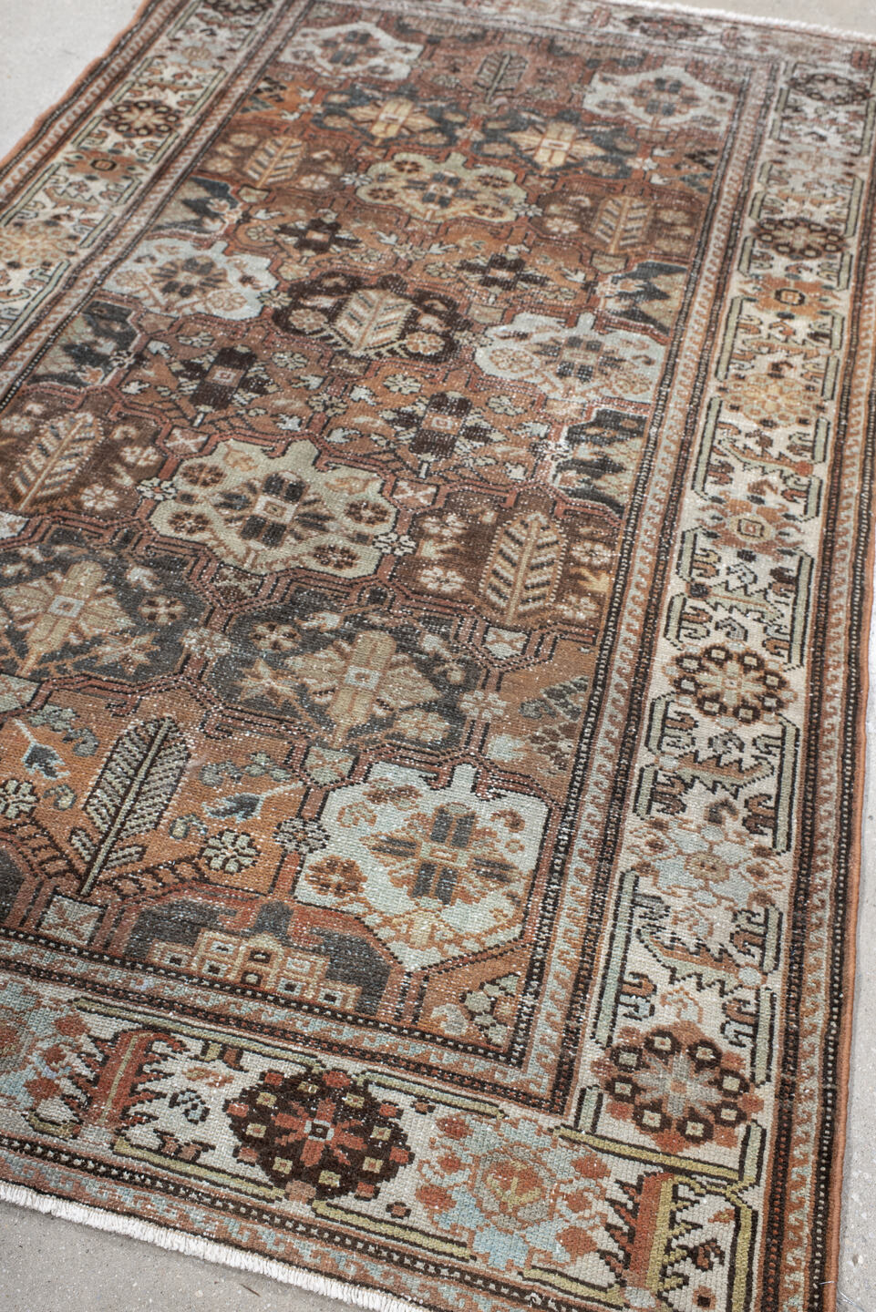 4' x 7' one-of-a-kind handmade vintage Baktiary rug. Color palette: black, brown, gray, light gray, off-white, pink, red