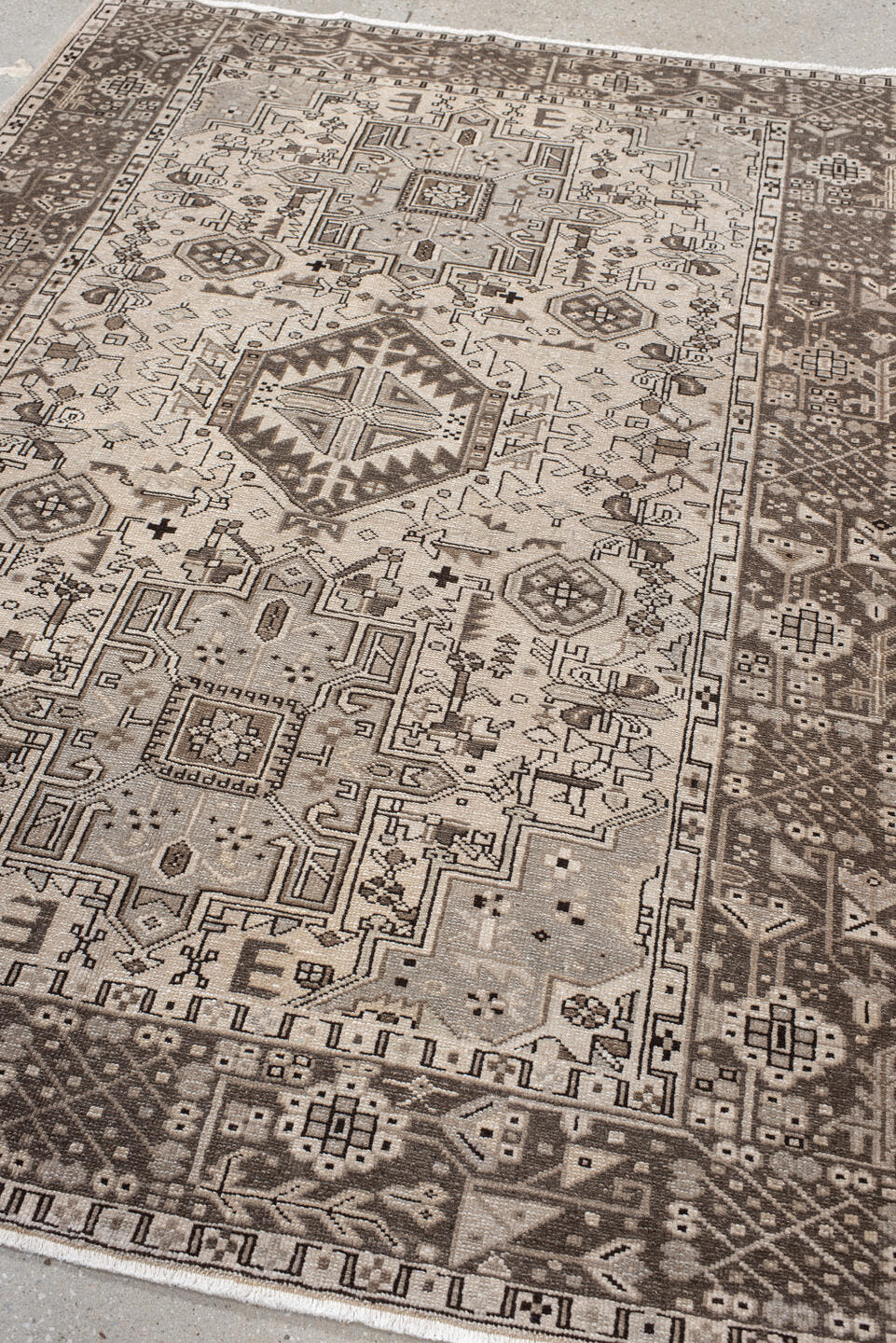 5' x 6' one-of-a-kind handmade antique Karaje rug. Color palette: ivory, brown, taupe, camel, charcoal, beige, gray, black