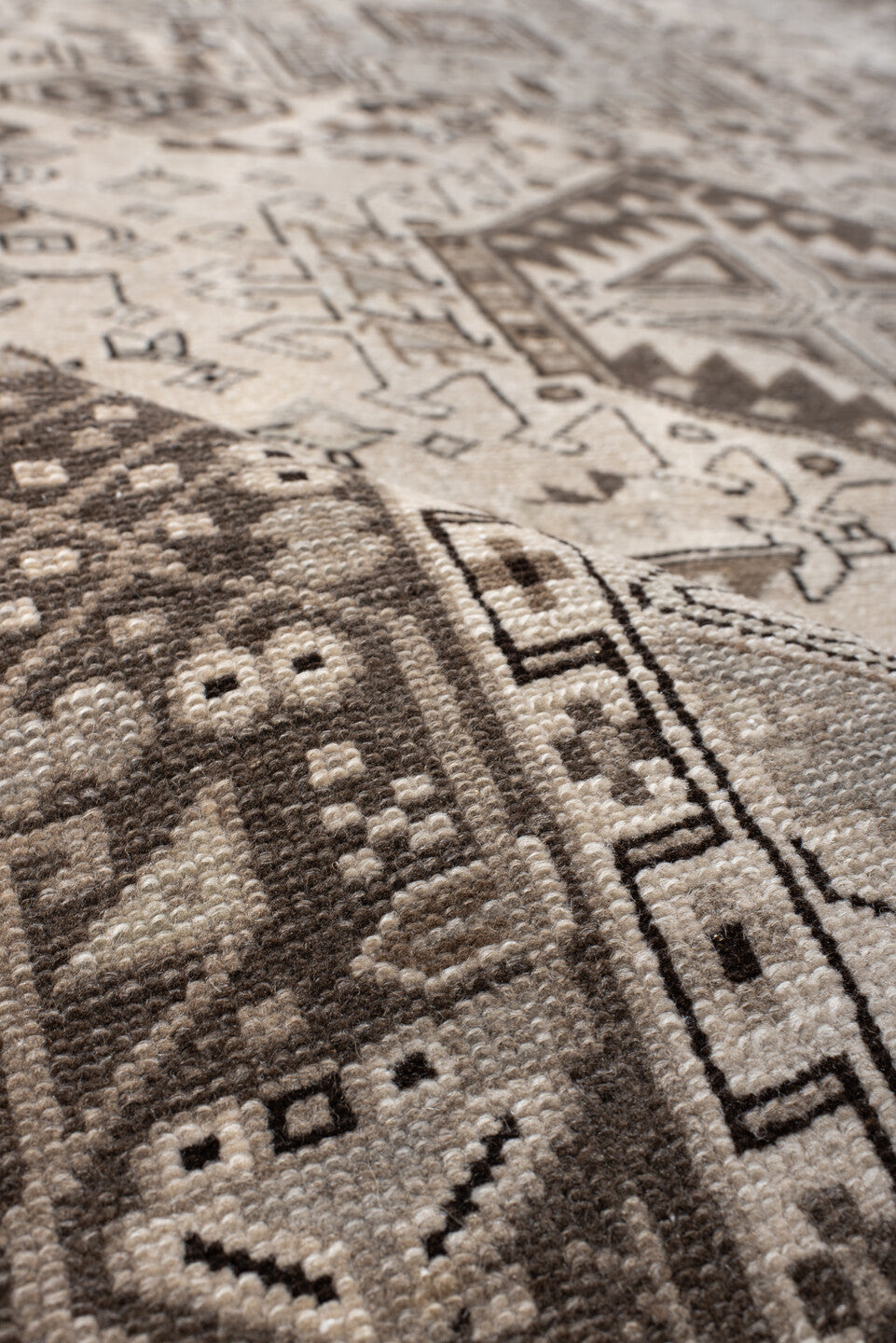 5' x 6' one-of-a-kind handmade vintage Karaje rug. Color palette: black, brown, gray, light gray, off-white, pink