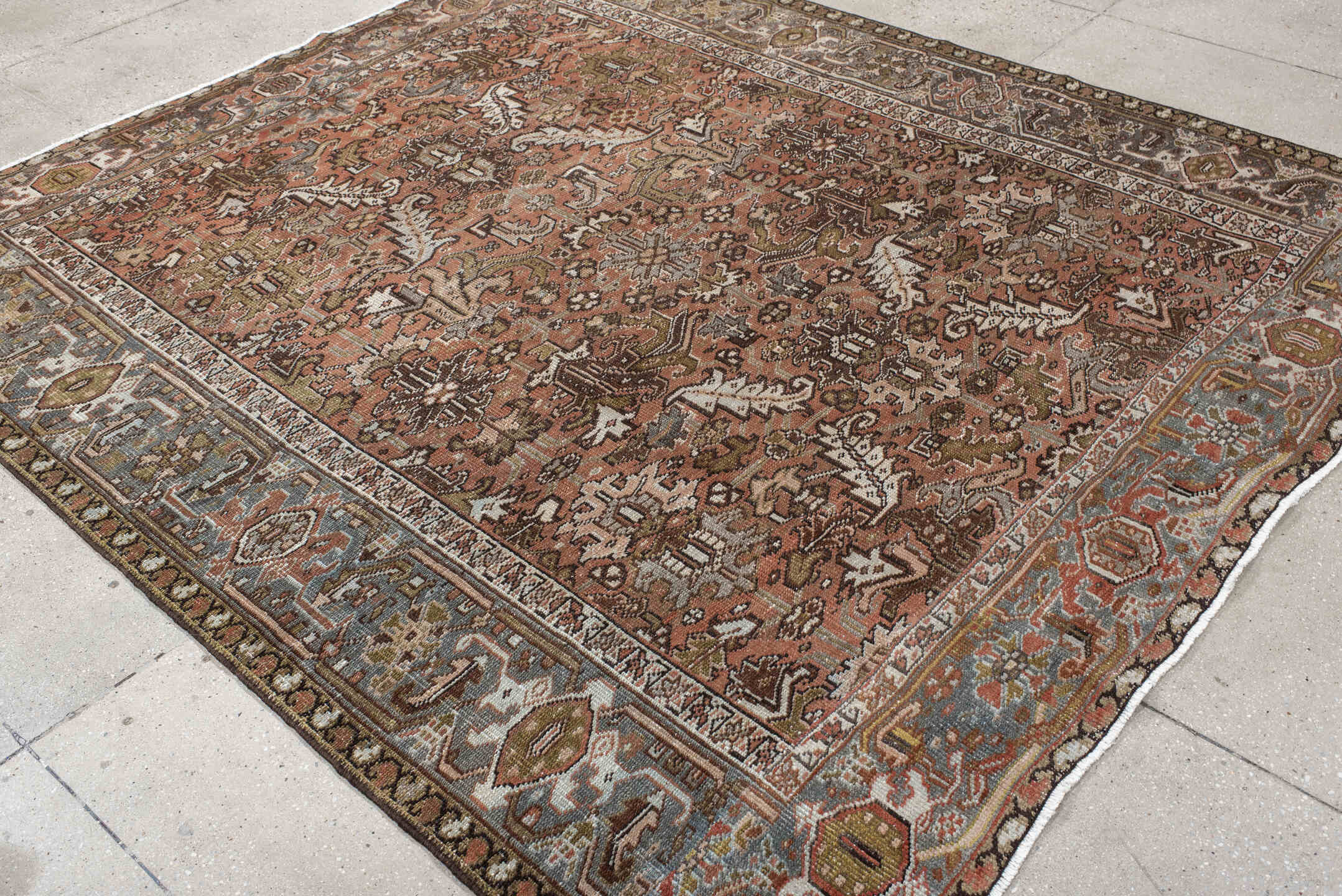 7' x 8' one-of-a-kind handmade antique Heriz rug. Color palette: terra cotta, slate, ivory, taupe, charcoal, olive, rust