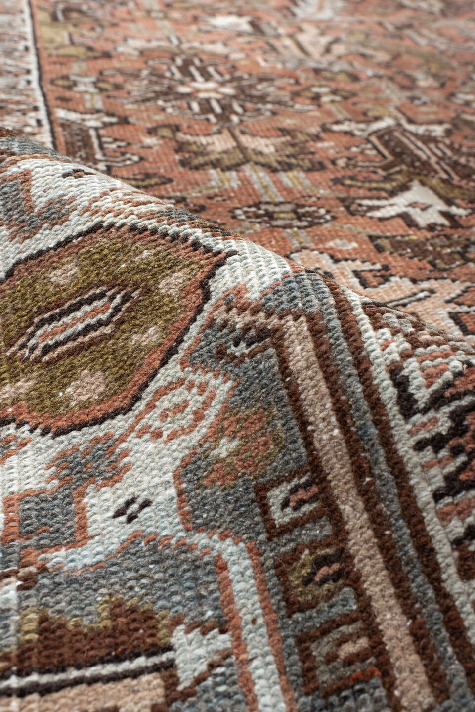 7' x 8' one-of-a-kind handmade antique Heriz rug. Color palette: terra cotta, slate, ivory, taupe, charcoal, olive, rust