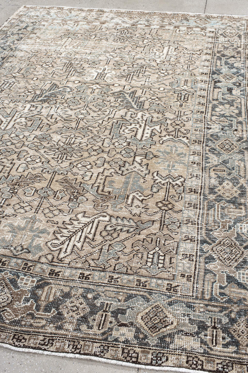 7' x 9' one-of-a-kind handmade antique Heriz rug. Color palette: ivory, taupe, slate, charcoal, camel, pale blue, brown