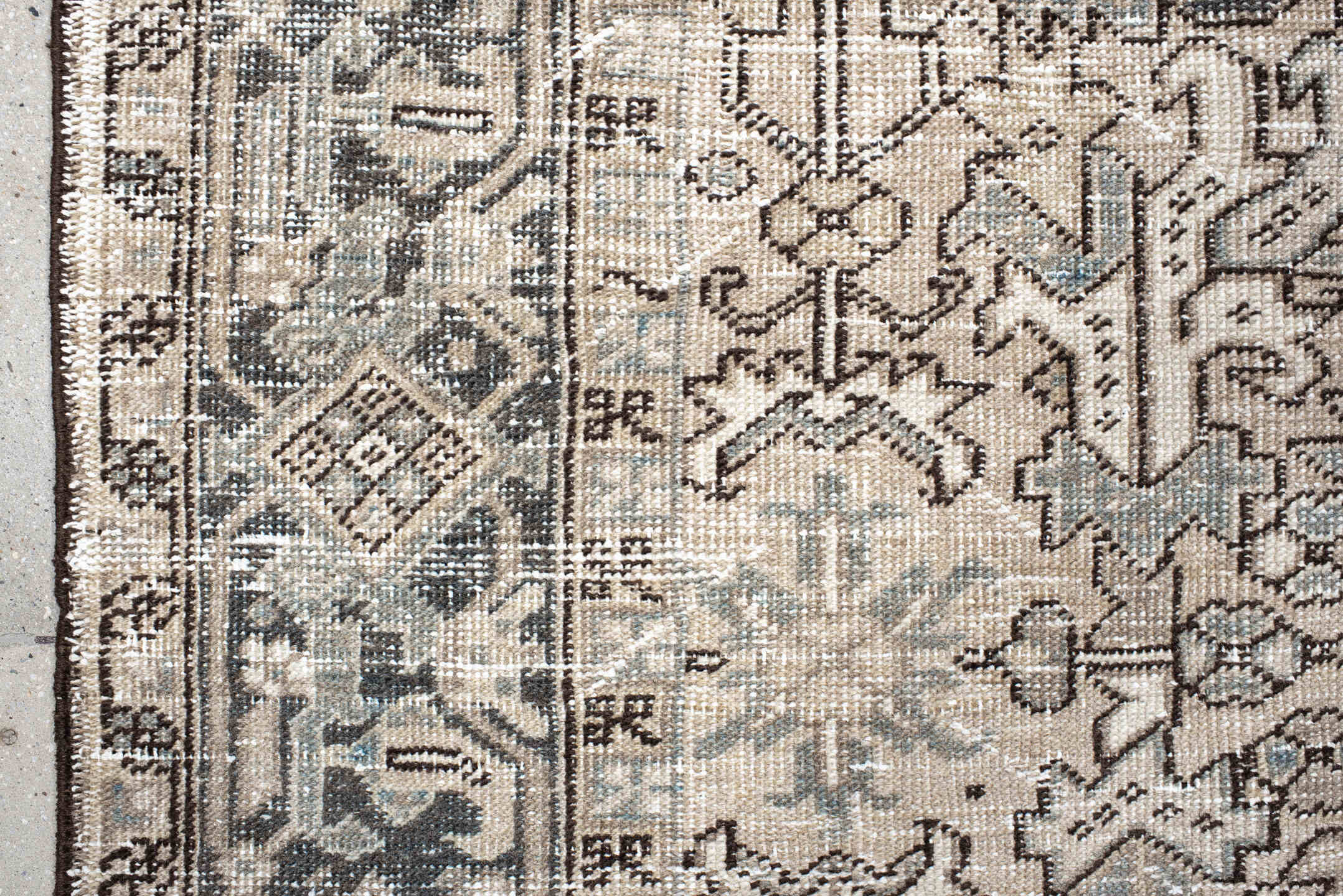 7' x 9' one-of-a-kind handmade antique Heriz rug. Color palette: ivory, taupe, slate, charcoal, camel, pale blue, brown
