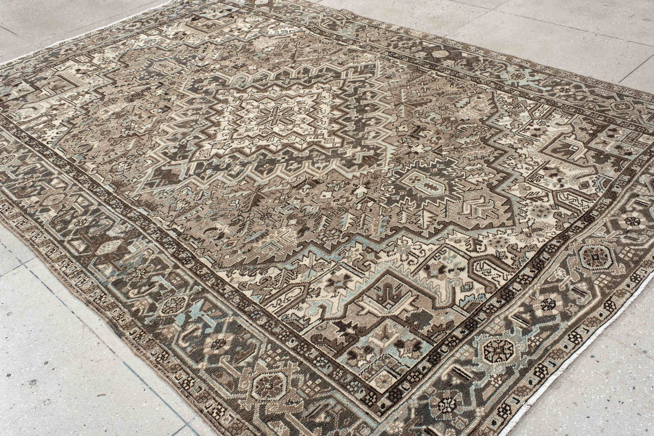 7' x 11' one-of-a-kind handmade antique Heriz large size rug. Color palette: taupe, brown, ivory, charcoal, pale blue, camel