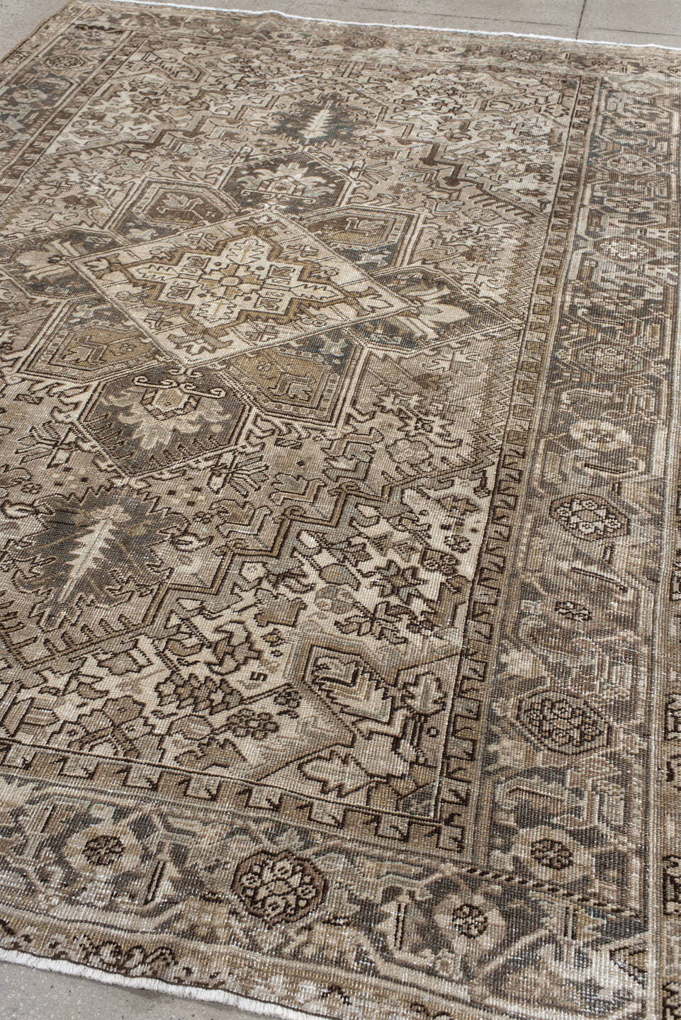 6' x 9' one-of-a-kind handmade antique Heriz rug. Color palette: ivory, taupe, camel, charcoal, brown, sage, beige, gray