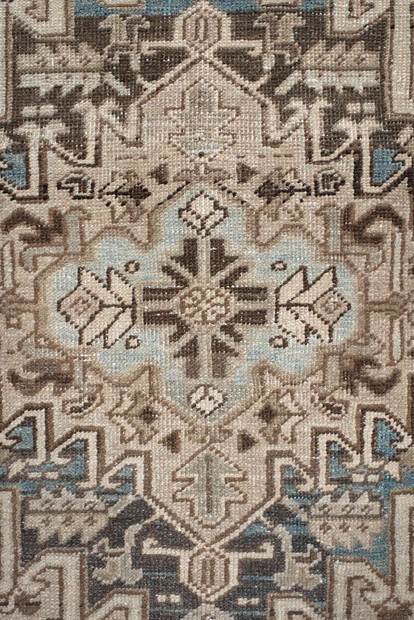 7' x 9' one-of-a-kind handmade antique Heriz rug. Color palette: ivory, taupe, charcoal, beige, sky blue, brown, gray, black