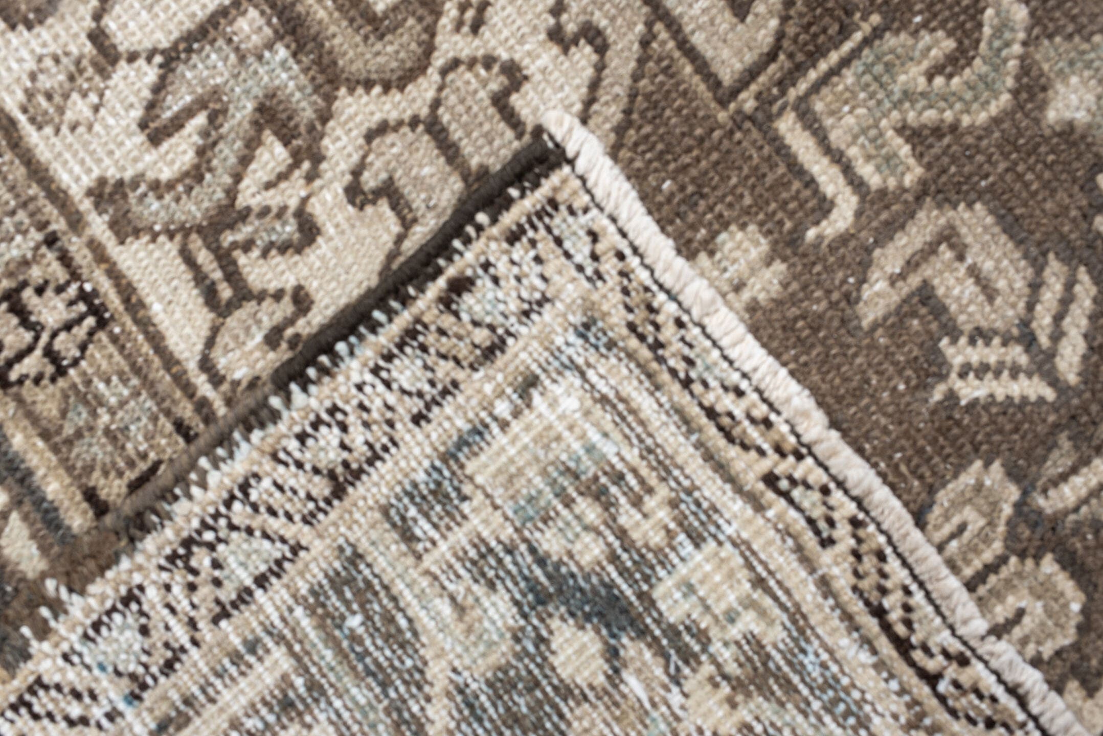 7' x 9' one-of-a-kind handmade antique Heriz rug. Color palette: ivory, taupe, charcoal, beige, sky blue, brown, gray, black
