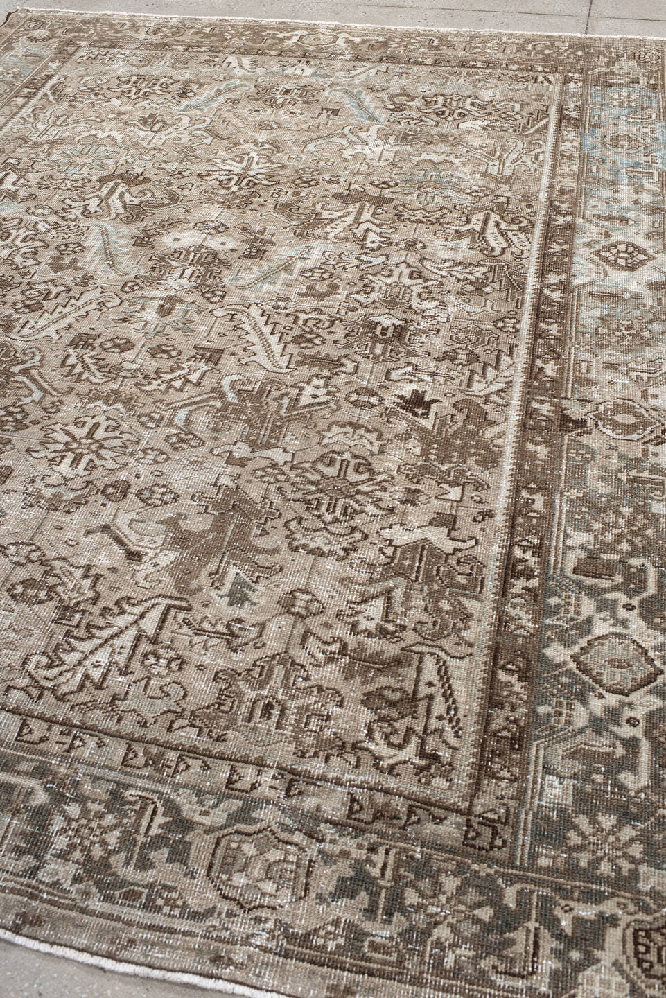 7' x 9' one-of-a-kind handmade antique Heriz rug. Color palette: taupe, brown, ivory, beige, pale blue, camel, gray