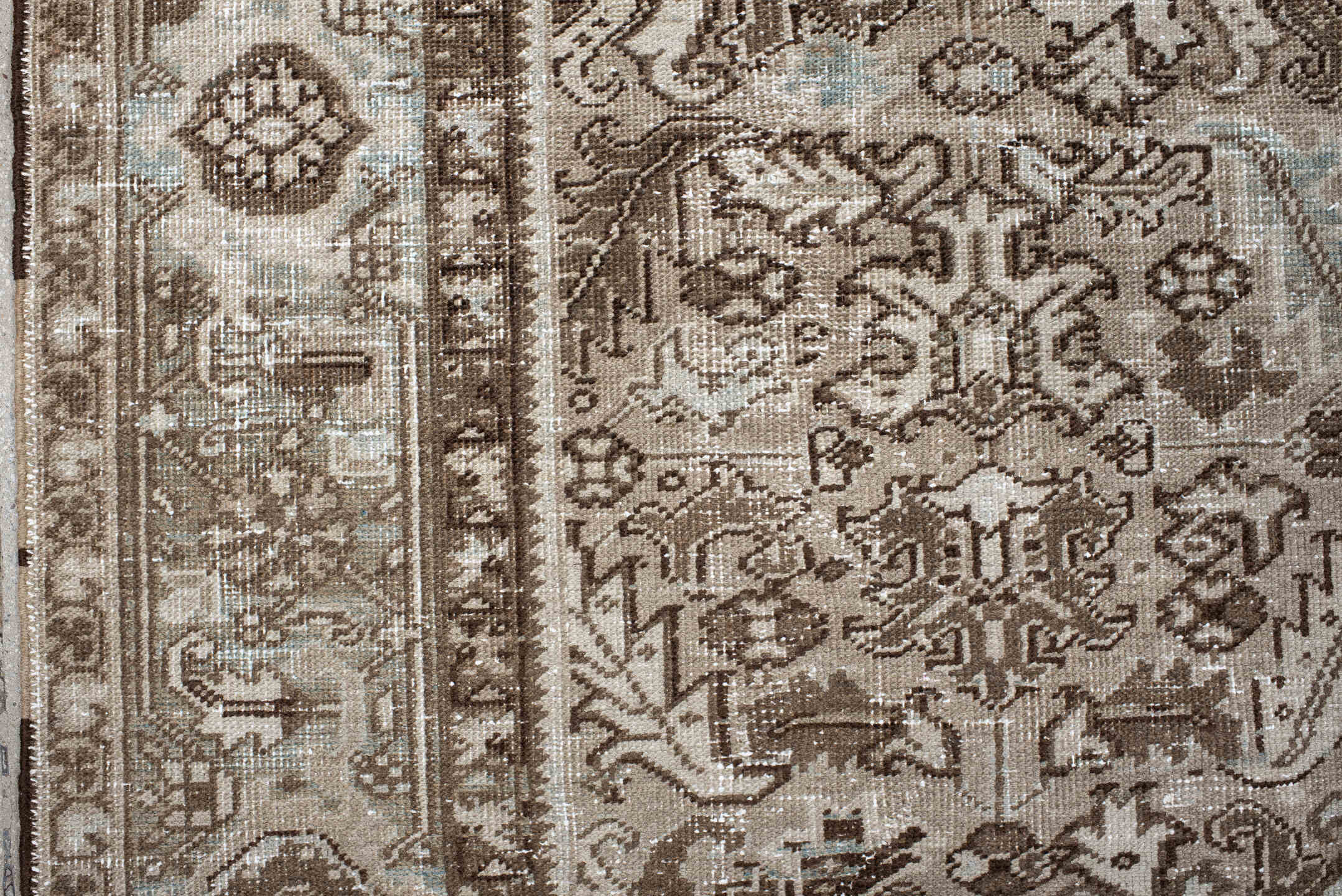 7' x 9' one-of-a-kind handmade antique Heriz rug. Color palette: taupe, brown, ivory, beige, pale blue, camel, gray