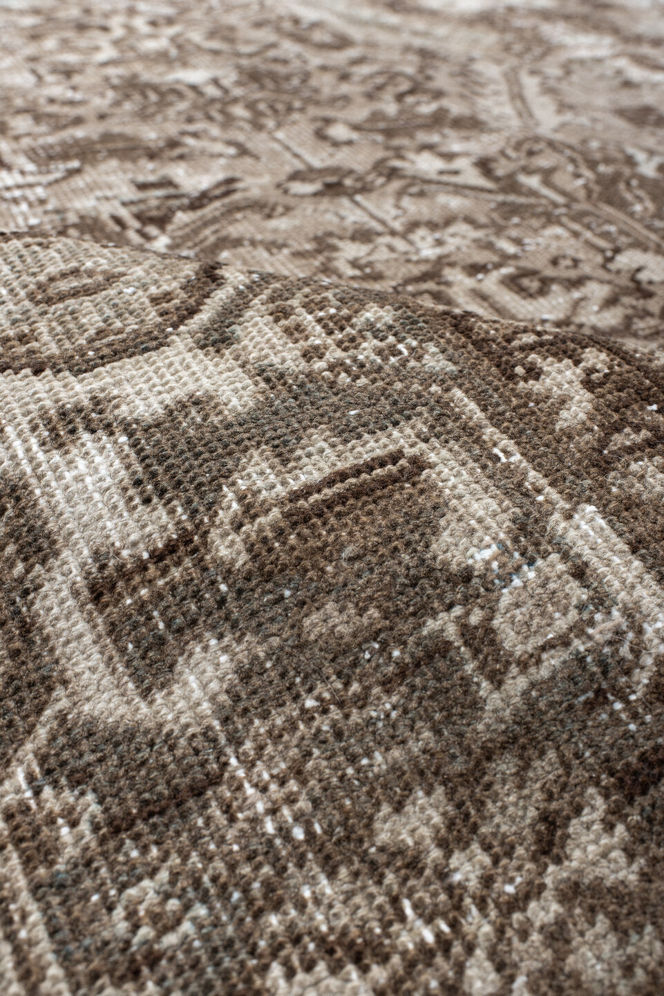 7' x 9' one-of-a-kind handmade antique Heriz rug. Color palette: taupe, brown, ivory, beige, pale blue, camel, gray