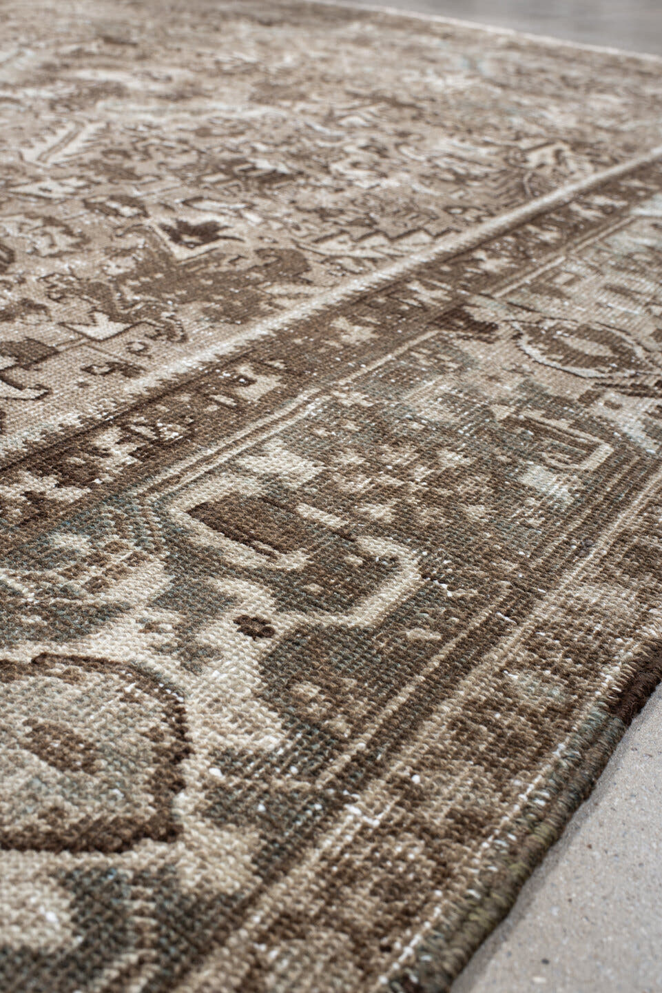 7' x 9' one-of-a-kind handmade antique Heriz rug. Color palette: taupe, brown, ivory, beige, pale blue, camel, gray
