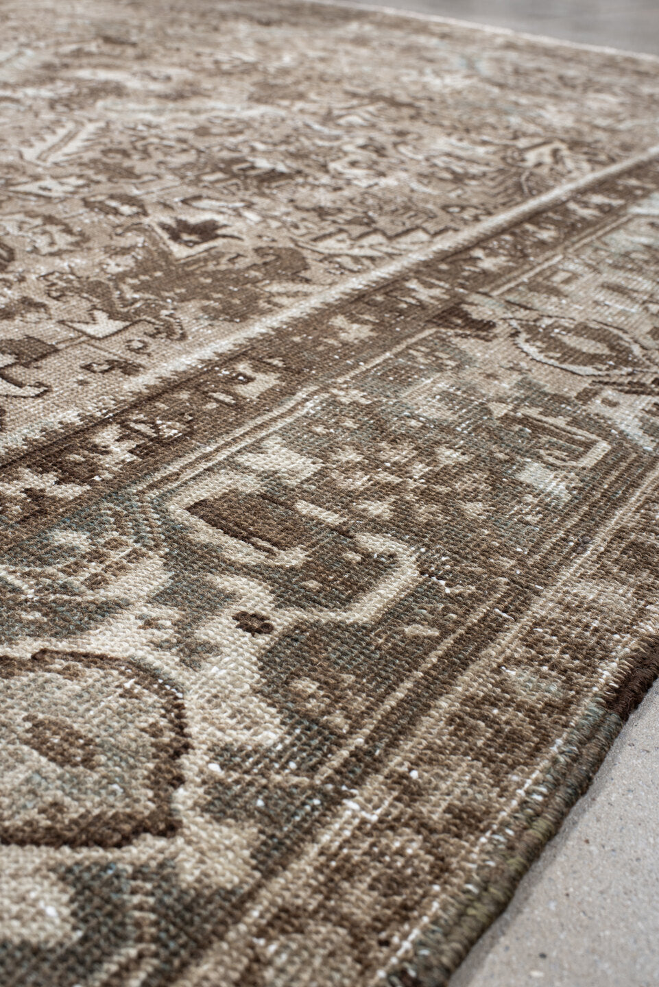 7' x 9' one-of-a-kind handmade antique Heriz rug. Color palette: taupe, brown, ivory, beige, pale blue, camel, gray