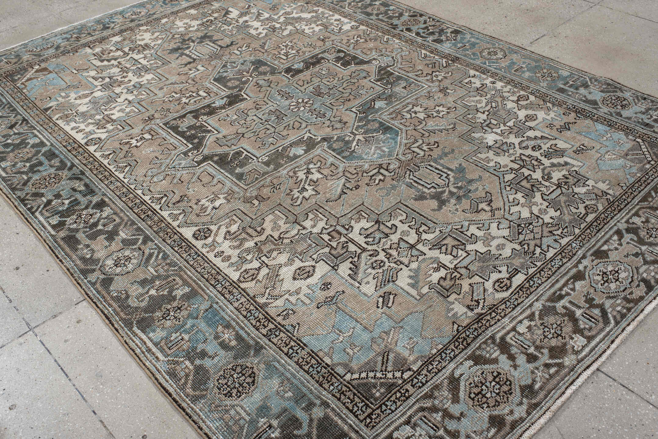 6' x 9' one-of-a-kind handmade antique Heriz medium size rug. Color palette: taupe, sky blue, charcoal, ivory, slate, brown