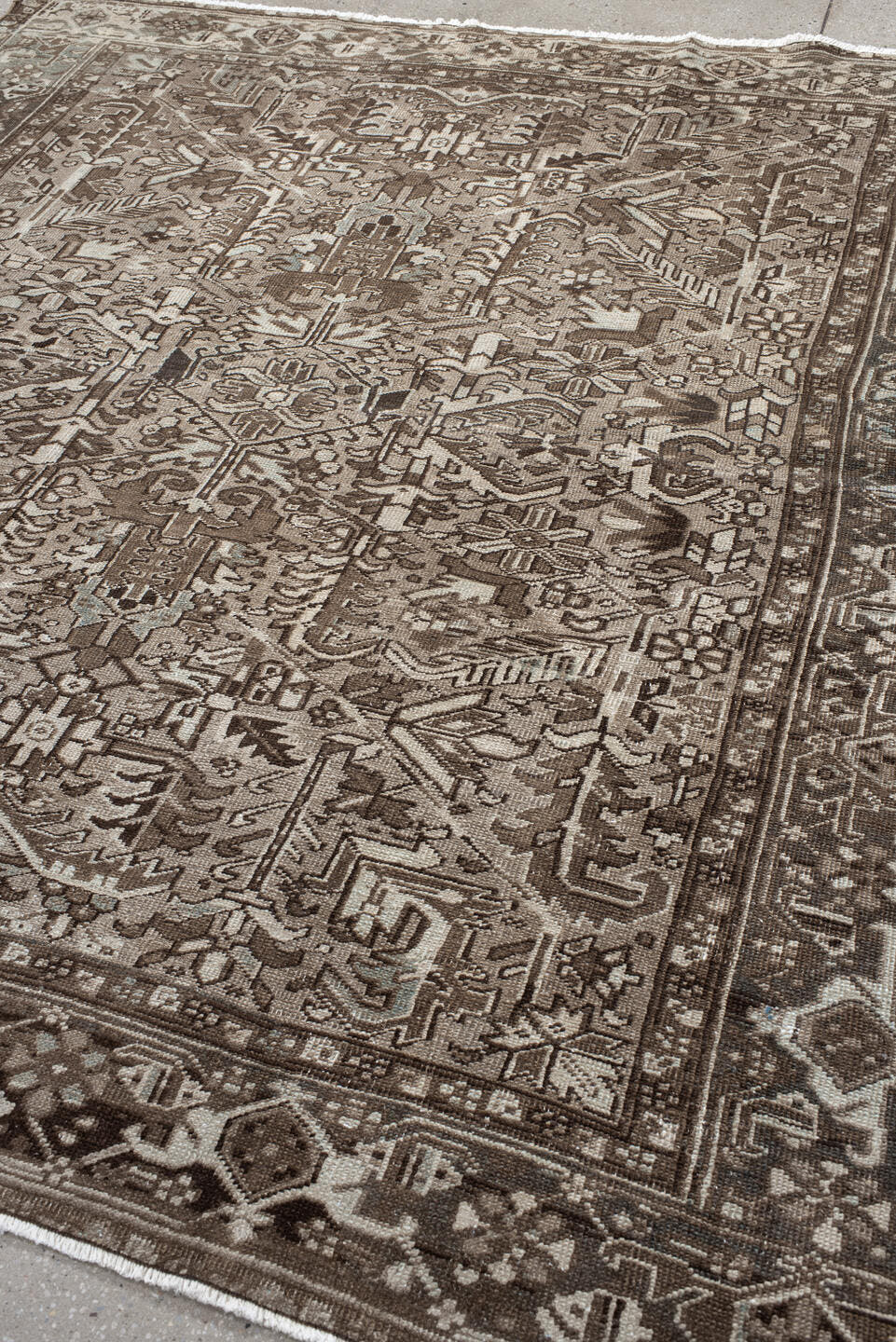 7' x 7' one-of-a-kind handmade antique Heriz rug. Color palette: taupe, brown, ivory, gray, charcoal, beige, black