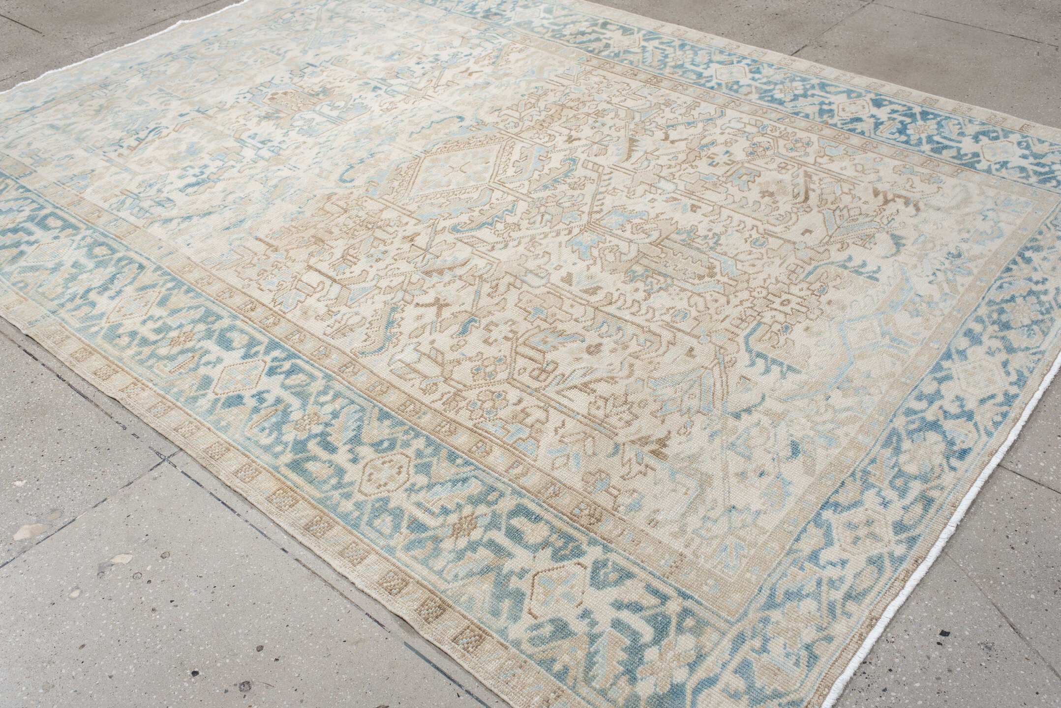 7' x 9' one-of-a-kind handmade antique Heriz large size rug. Color palette: ivory, sky blue, beige, taupe, camel, light blue