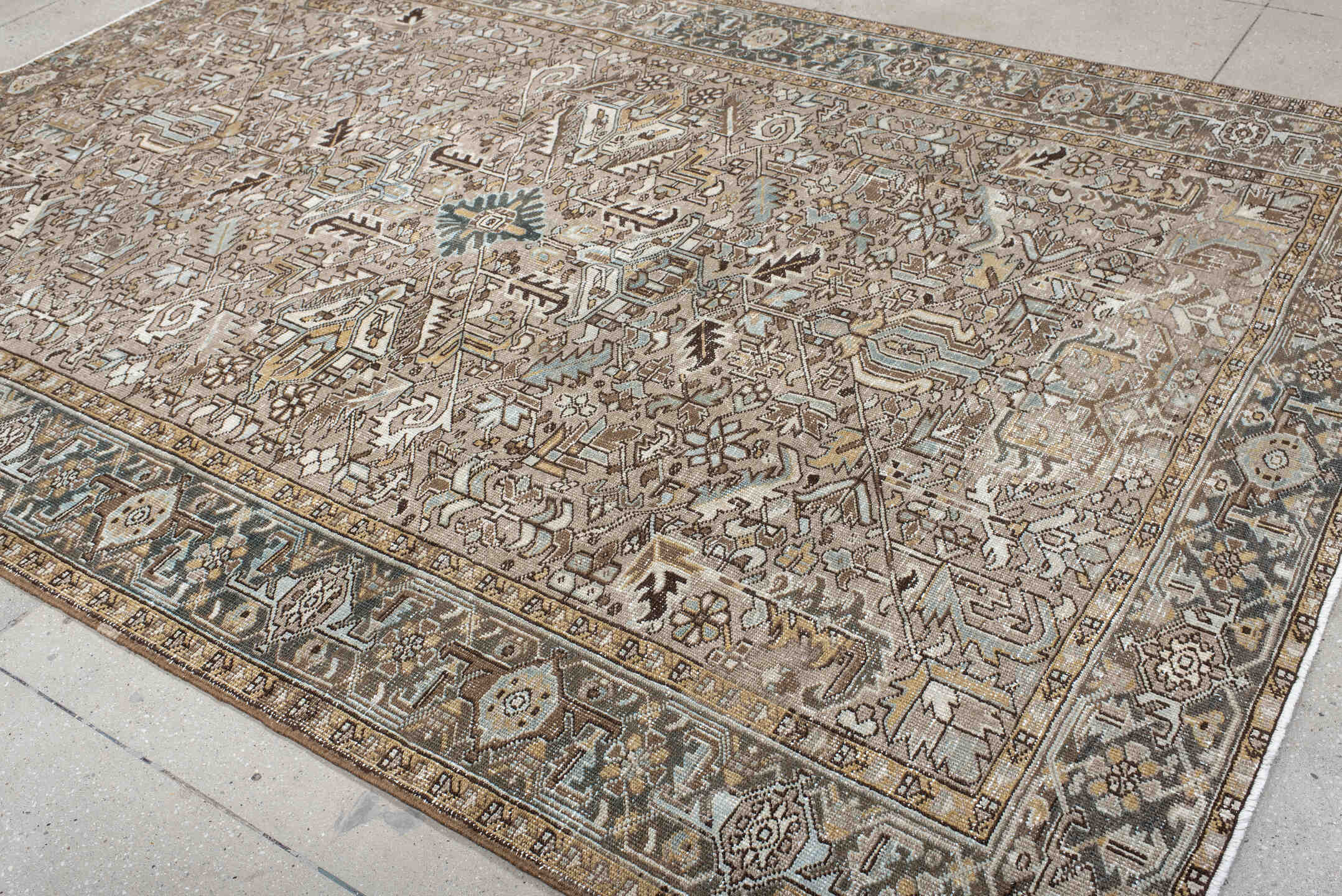 7' x 10' one-of-a-kind handmade antique Heriz large size rug. Color palette: taupe, ivory, slate, camel, brown, pale blue