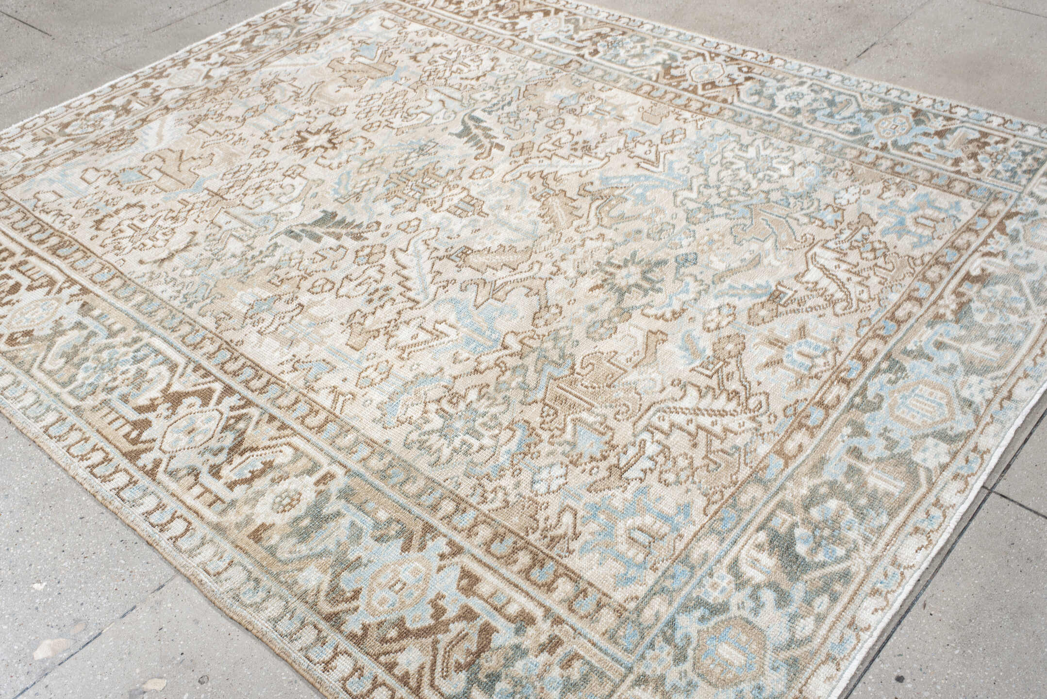 7' x 8' one-of-a-kind handmade antique Heriz rug. Color palette: ivory, camel, pale blue, taupe, light gray, sand, beige