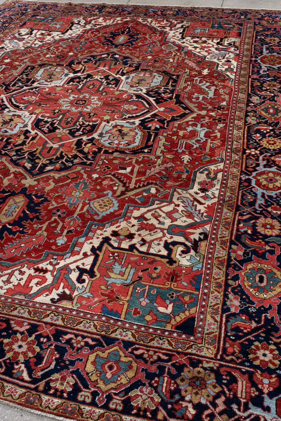 9' x 12' one-of-a-kind handmade antique Heriz large size rug. Color palette: rust, navy, ivory, sky blue, soft gold, coral