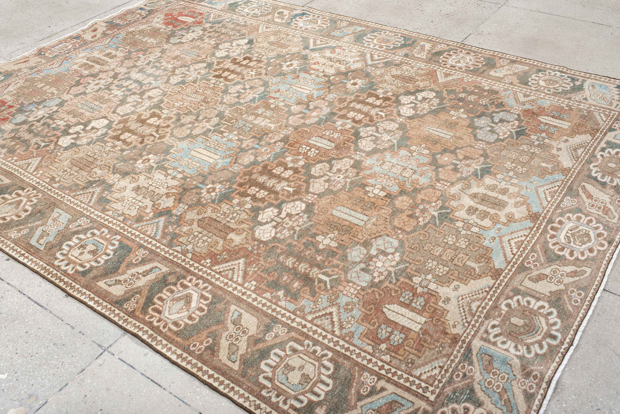 7' x 9' one-of-a-kind handmade vintage Baktiary rug. Color palette: taupe, charcoal, blush, ivory, sky blue, brown, rose