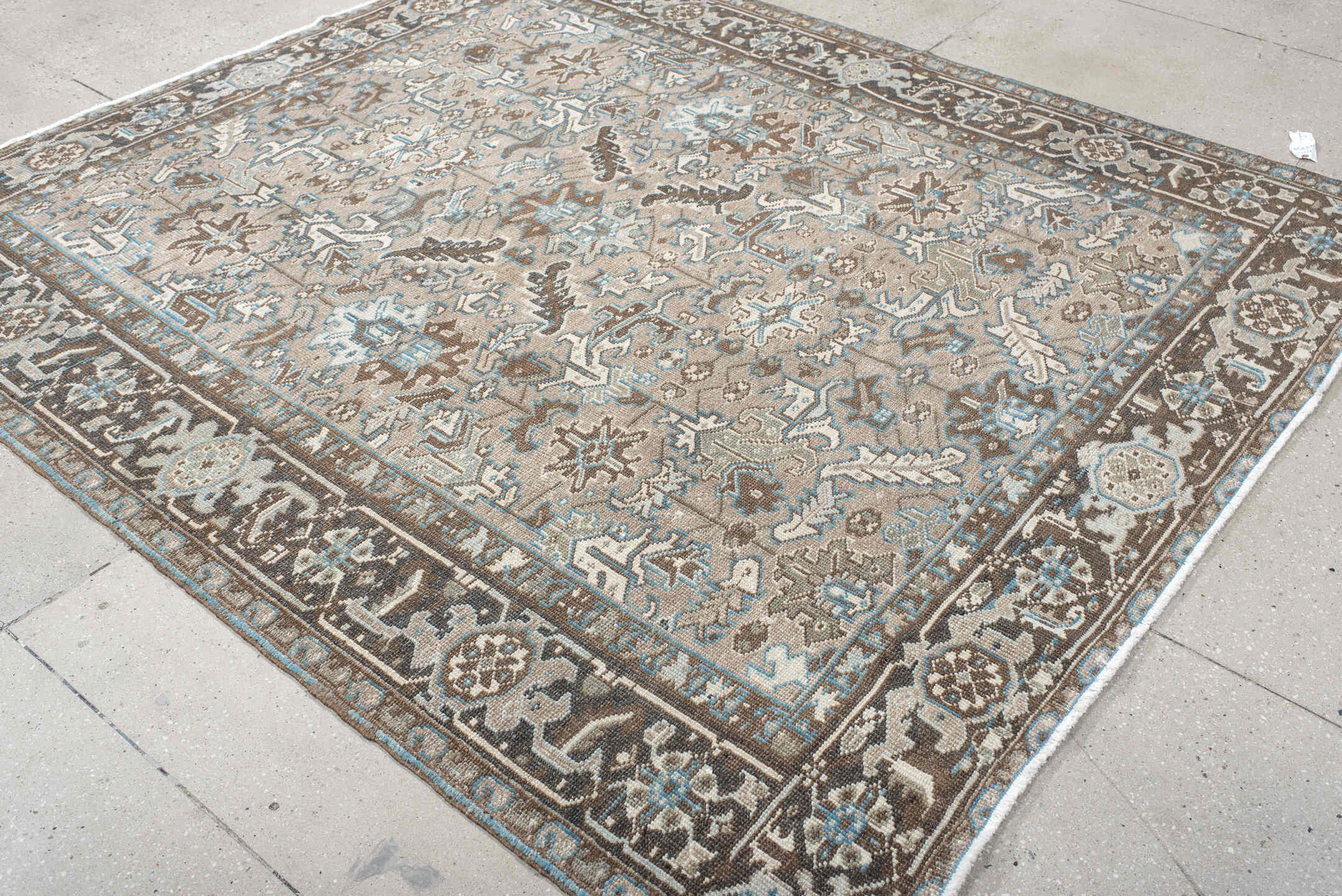 6' x 7' one-of-a-kind handmade antique Heriz rug. Color palette: taupe, brown, ivory, sky blue, charcoal, camel, beige, gray