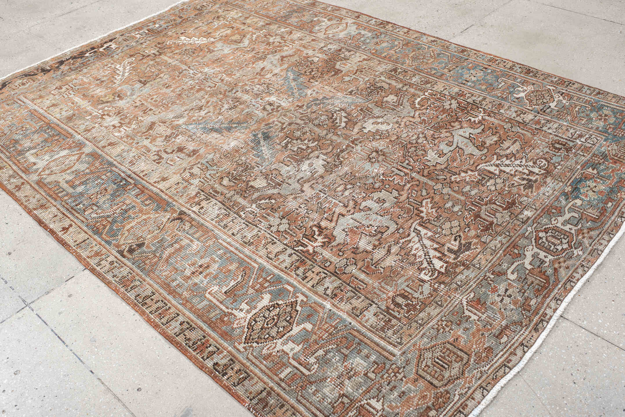 6' x 8' one-of-a-kind handmade antique Heriz medium size rug. Color palette: terra cotta, ivory, soft blue, taupe, rust