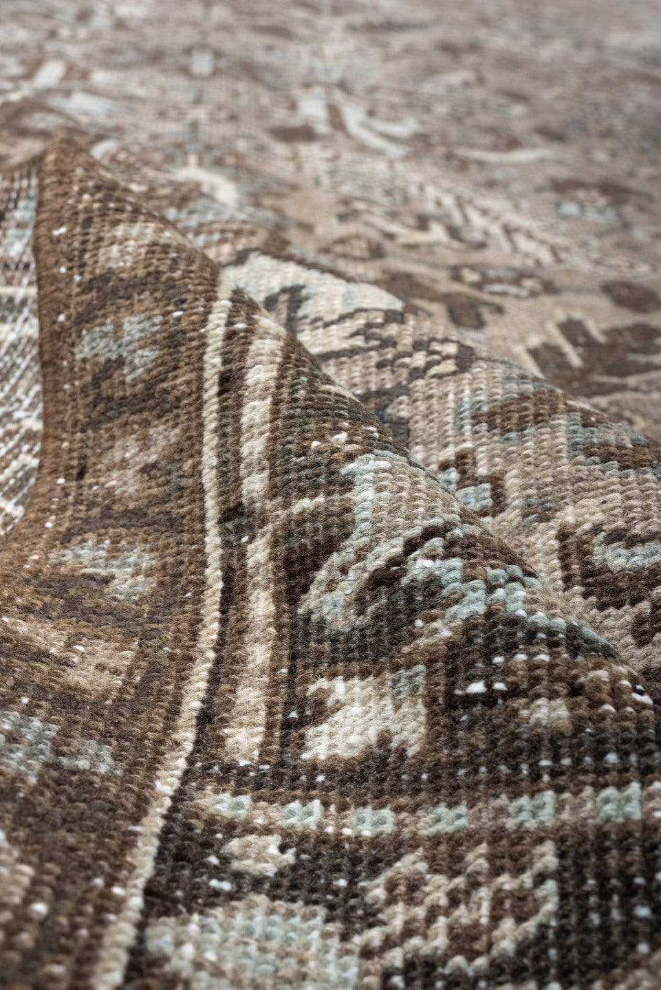 7' x 9' one-of-a-kind handmade vintage Heriz rug. Color palette: taupe, brown, ivory, pale blue, camel, charcoal, beige