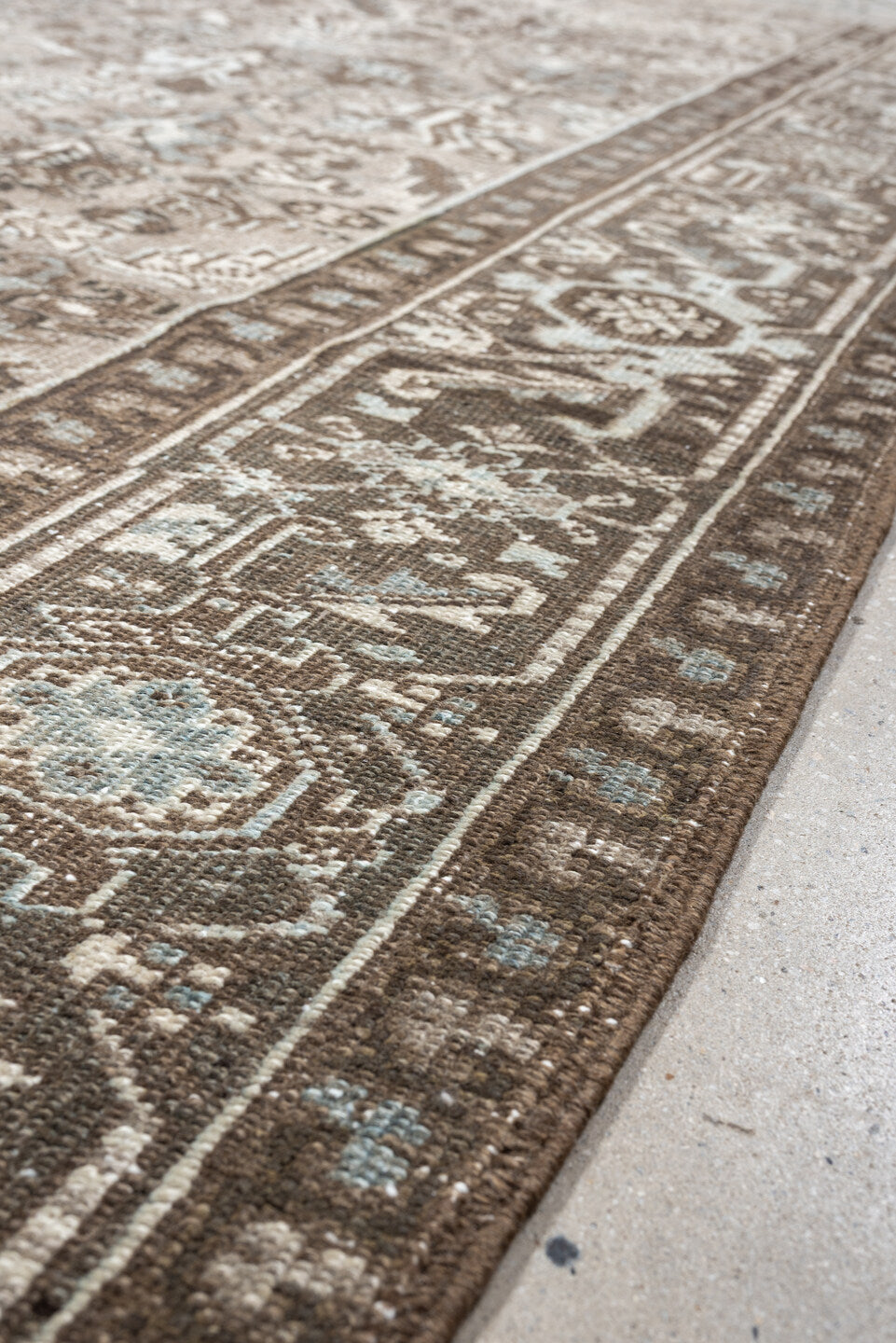 7' x 9' one-of-a-kind handmade vintage Heriz rug. Color palette: taupe, brown, ivory, pale blue, camel, charcoal, beige