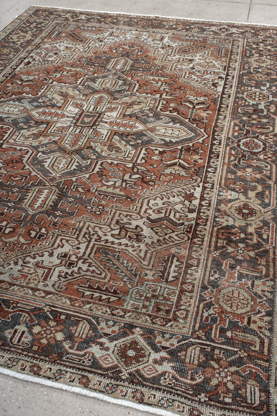 6' x 9' one-of-a-kind handmade antique Heriz medium size rug. Color palette: rust, ivory, navy, charcoal, camel, terra cotta
