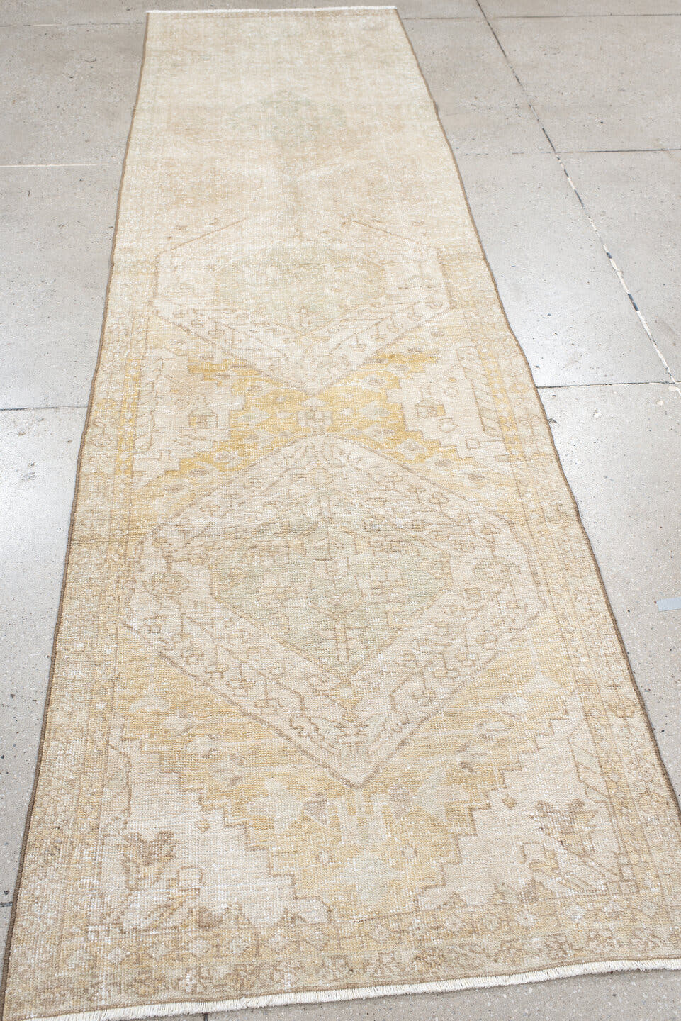 2' x 10' one-of-a-kind handmade vintage Karaje runner rug. Color palette: ivory, sand, cream, pale gold, taupe, sage, beige