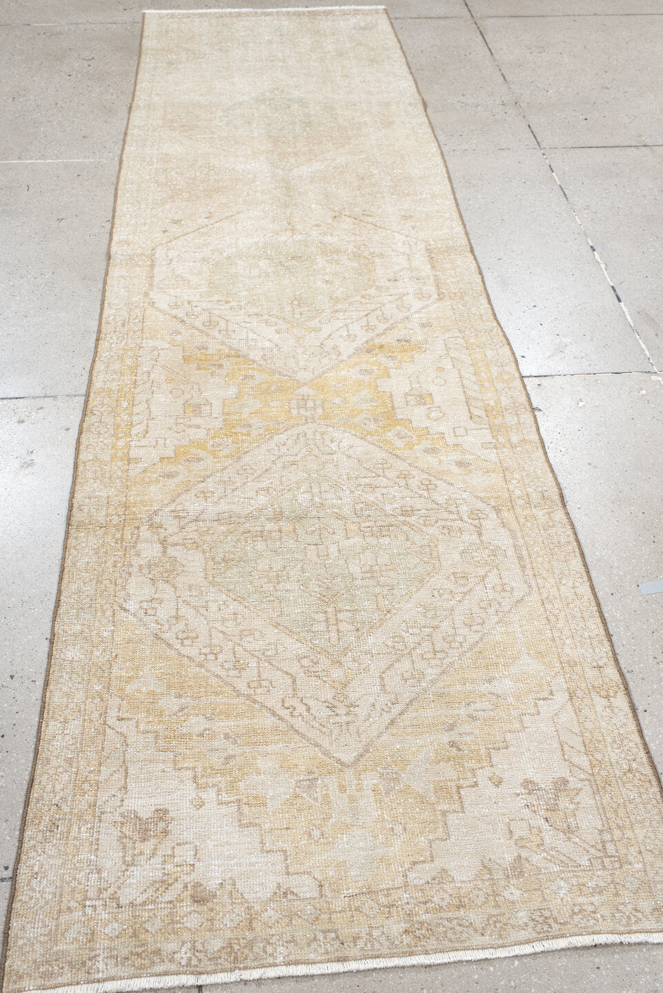 2' x 10' one-of-a-kind handmade vintage Karaje runner rug. Color palette: ivory, sand, cream, pale gold, taupe, sage, beige