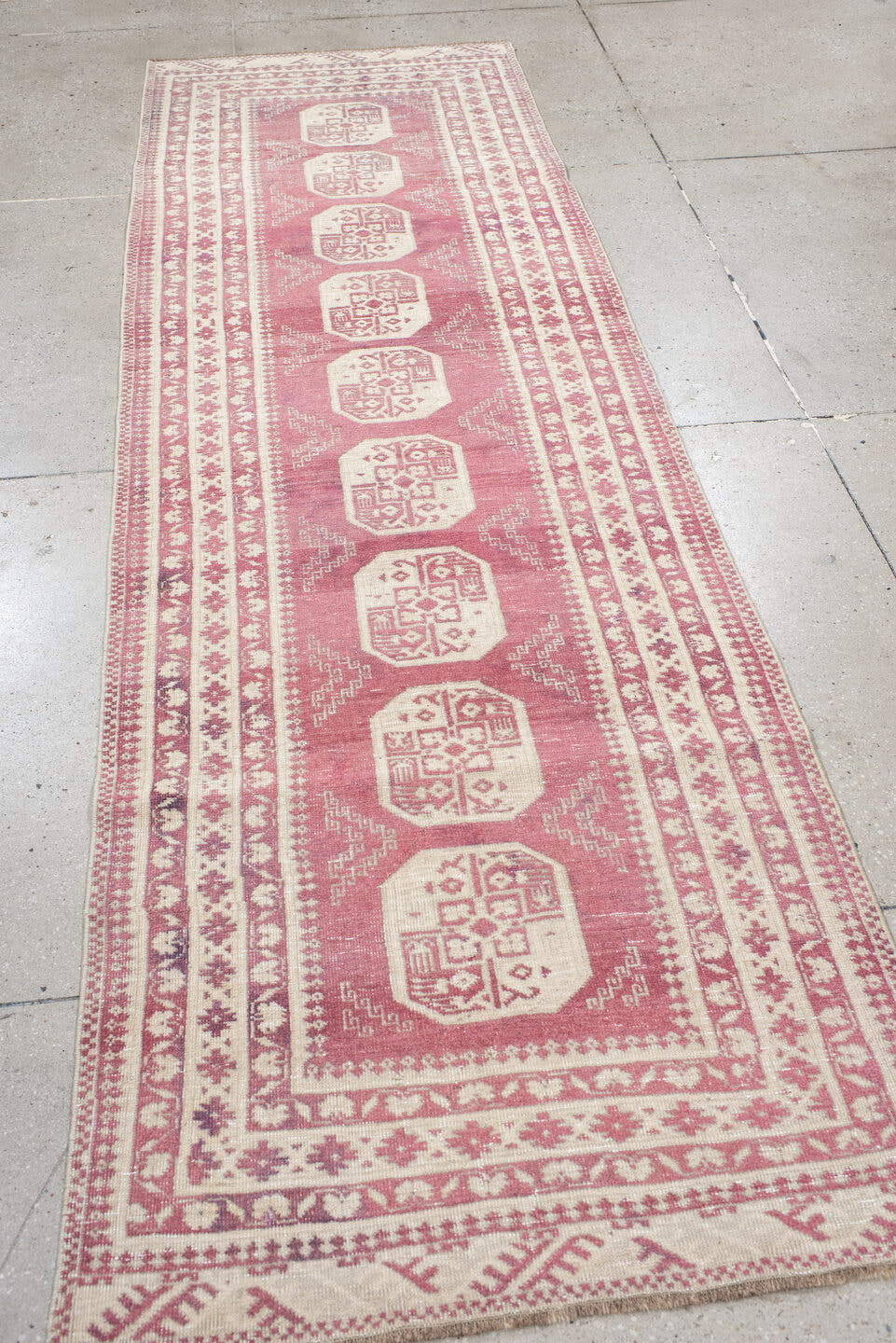3' x 10' one-of-a-kind handmade vintage Afghan runner rug. Color palette: rose, ivory, dusty pink, burgundy, pink, red