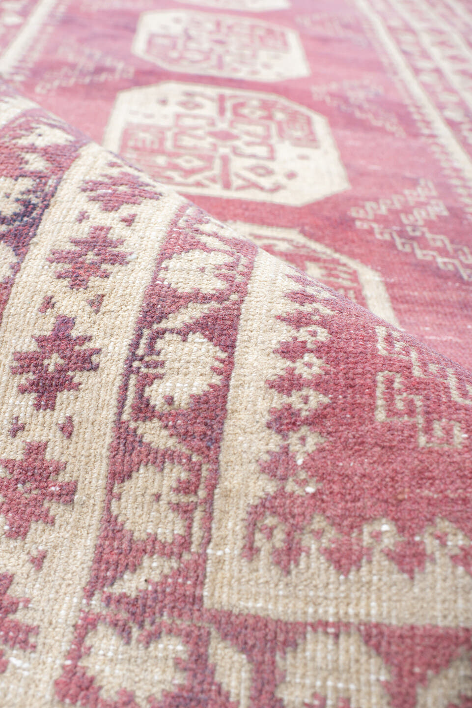 3' x 10' one-of-a-kind handmade vintage Afghan runner rug. Color palette: rose, ivory, dusty pink, burgundy, pink, red