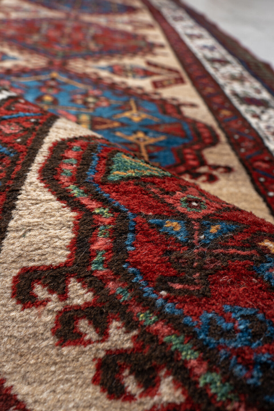 3' x 10' one-of-a-kind handmade antique Sarab runner rug. Color palette: ivory, rust, sky blue, crimson, navy, teal, brown