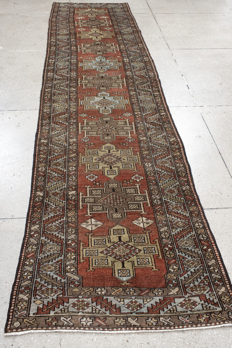 3' x 12' one-of-a-kind handmade antique Heriz runner rug. Color palette: rust, brown, ivory, sky blue, taupe, charcoal