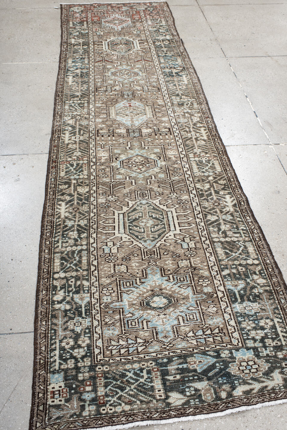 2' x 10' one-of-a-kind handmade vintage Karaje runner rug. Color palette: taupe, charcoal, ivory, pale blue, rust, brown