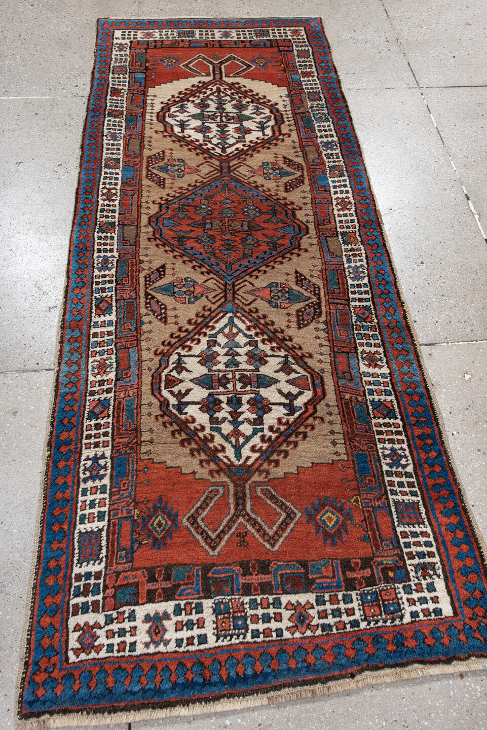 2' x 6' one-of-a-kind handmade antique Sarab runner rug. Color palette: ivory, sky blue, rust, navy, terracotta, brown