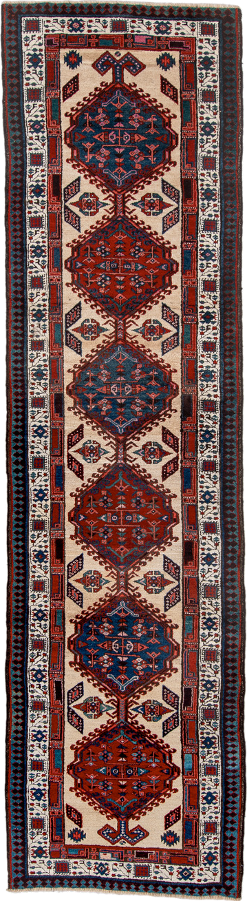 3' x 11' one-of-a-kind handmade antique Sarab runner rug. Color palette: ivory, rust, indigo, navy, crimson, charcoal